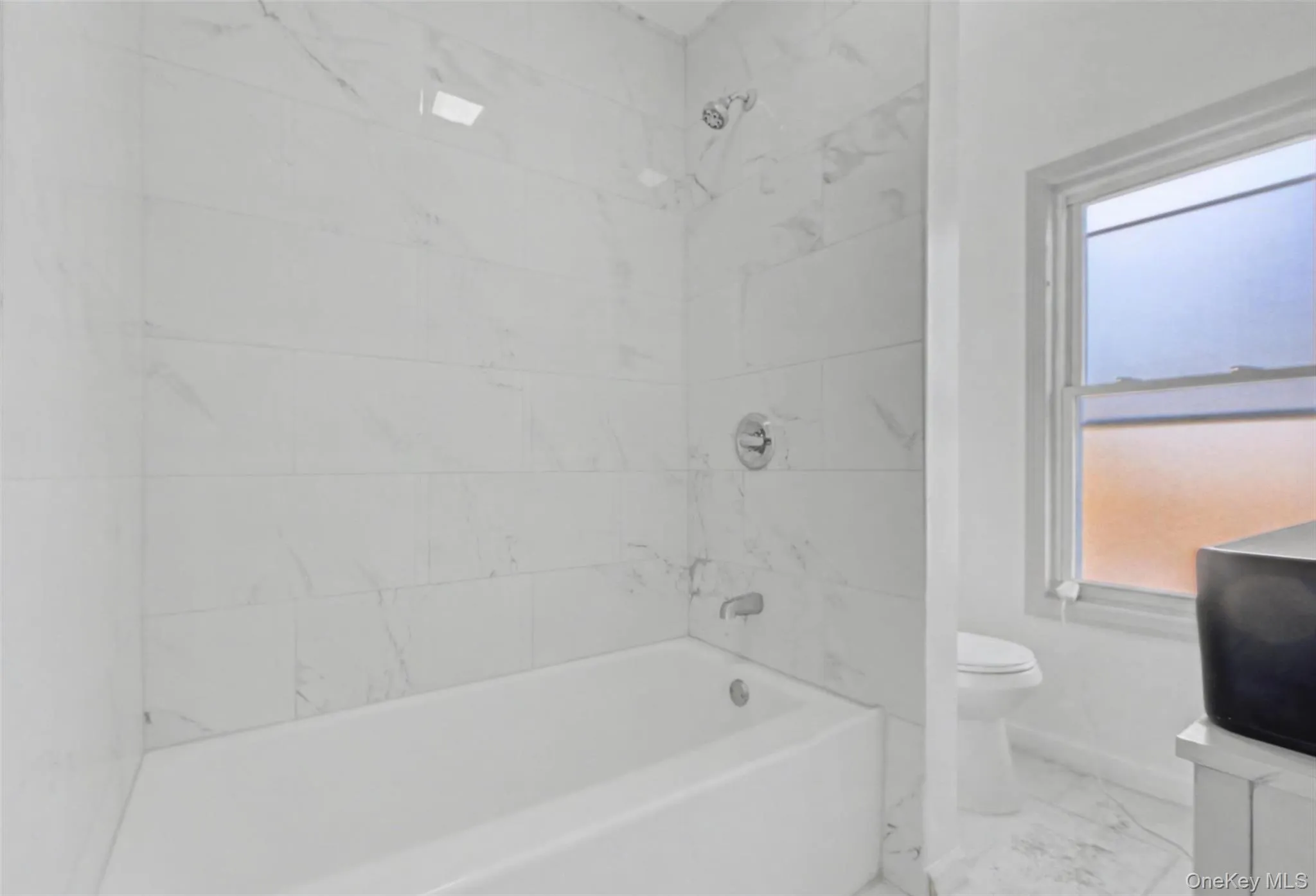 a beautiful tub/shower combo with elegant tile work a beautiful tub/shower combo with elegant tile work