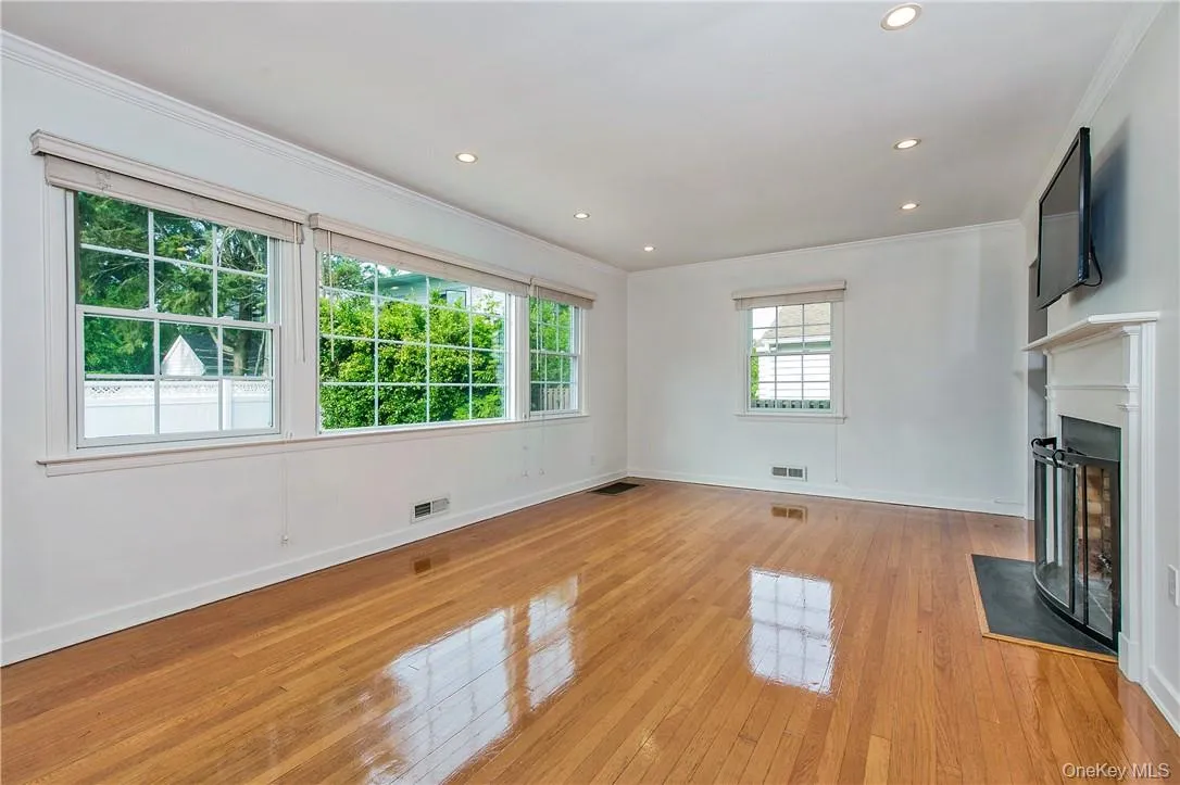 Light-filled Living Room with walls of windows and wood burning fireplace. Light-filled Living Room with walls of windows and wood burning fireplace.