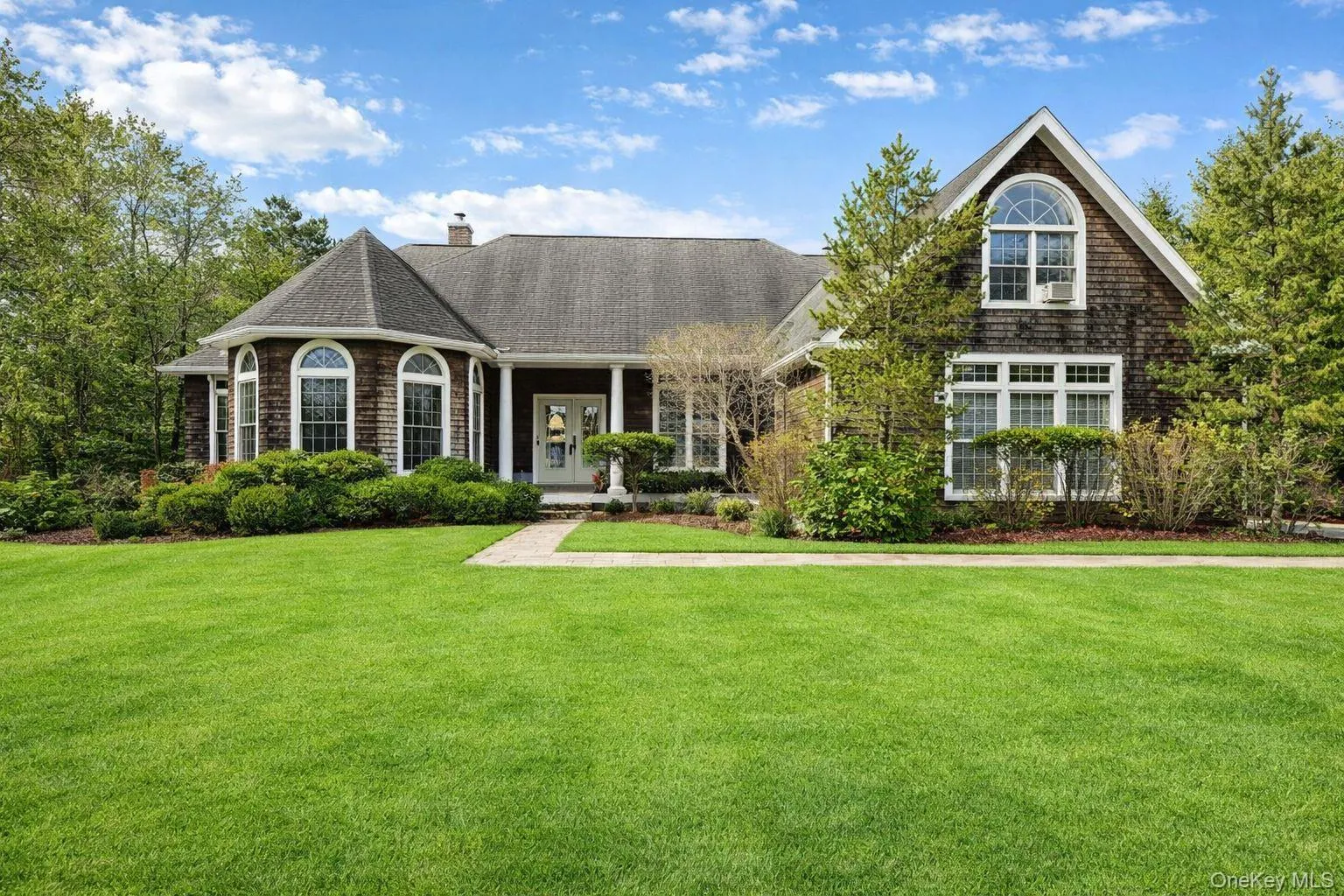 View of front of home featuring covered porch & large lawn View of front of home featuring covered porch & large lawn