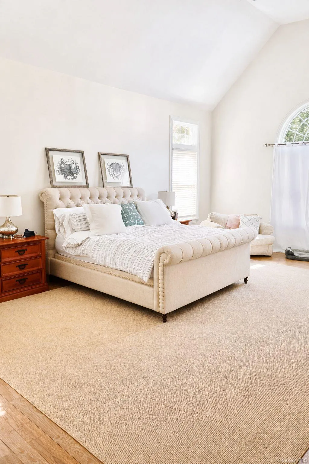 Bedroom with vaulted ceiling and light wood finished floors Bedroom with vaulted ceiling and light wood finished floors
