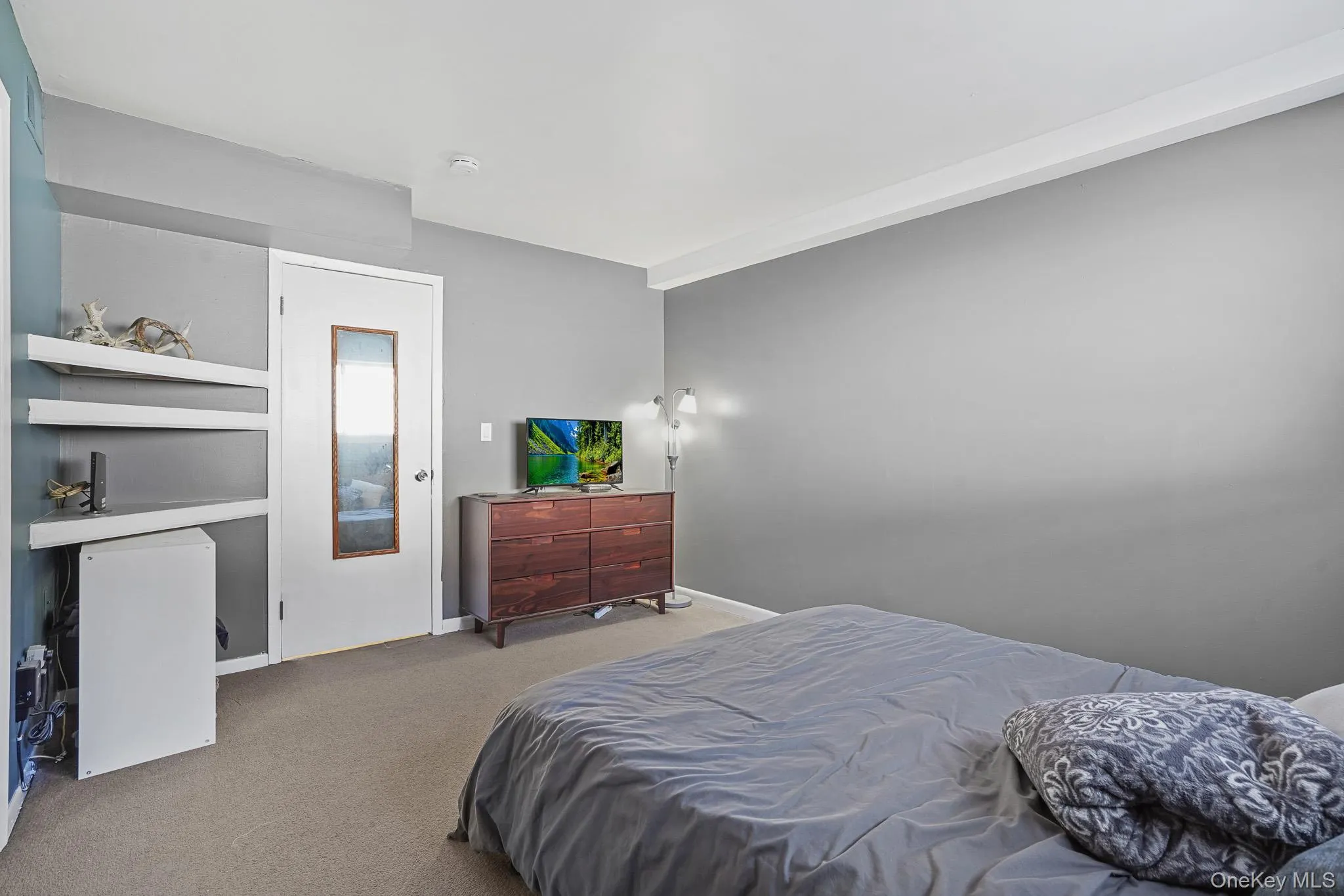 Bedroom with carpet flooring and baseboards Bedroom with carpet flooring and baseboards
