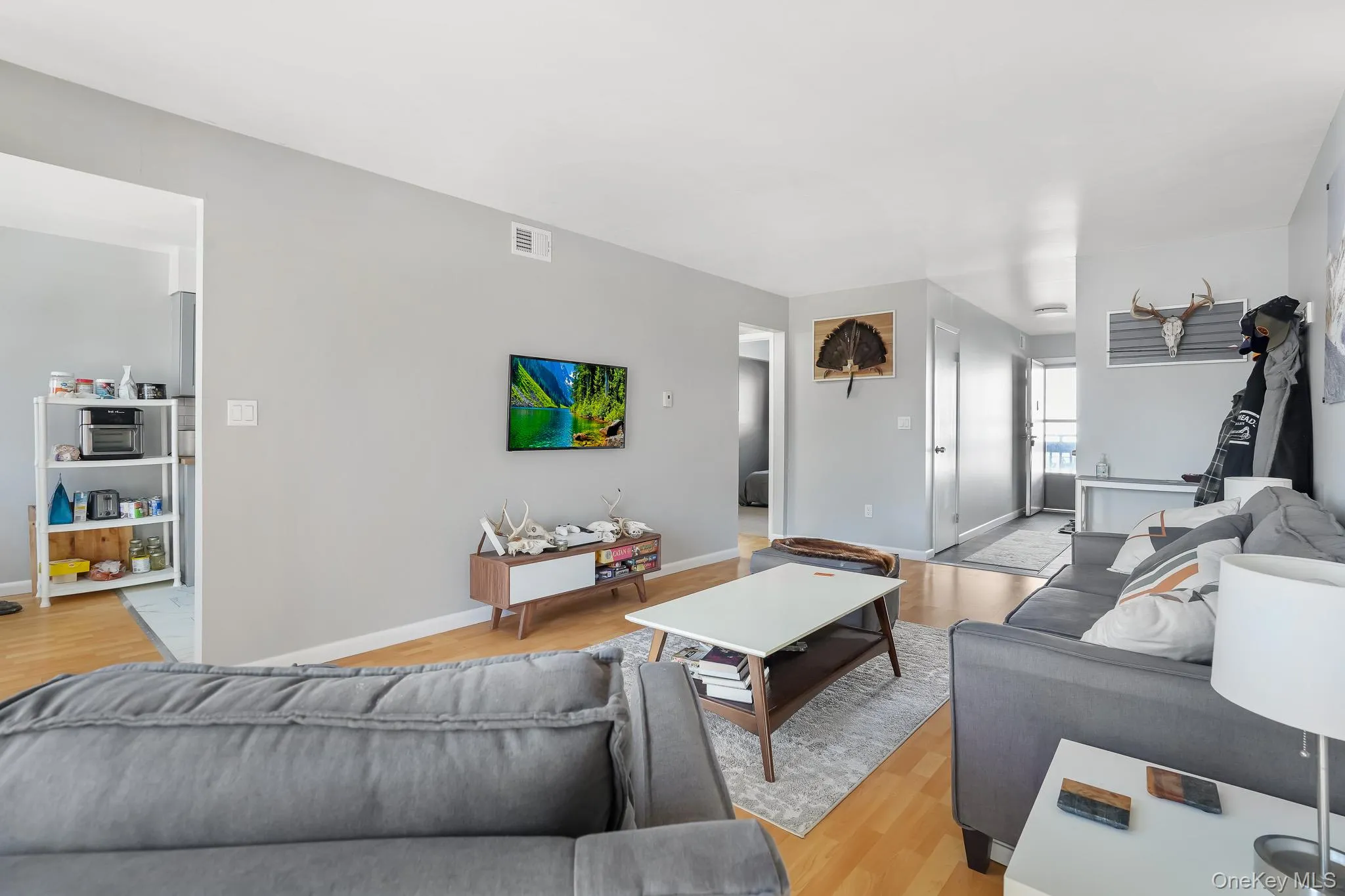 Living room featuring light wood-style floors and baseboards Living room featuring light wood-style floors and baseboards