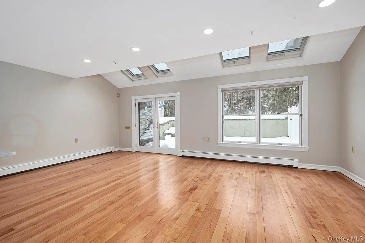 Family room with skylights and doors out to private patio Family room with skylights and doors out to private patio