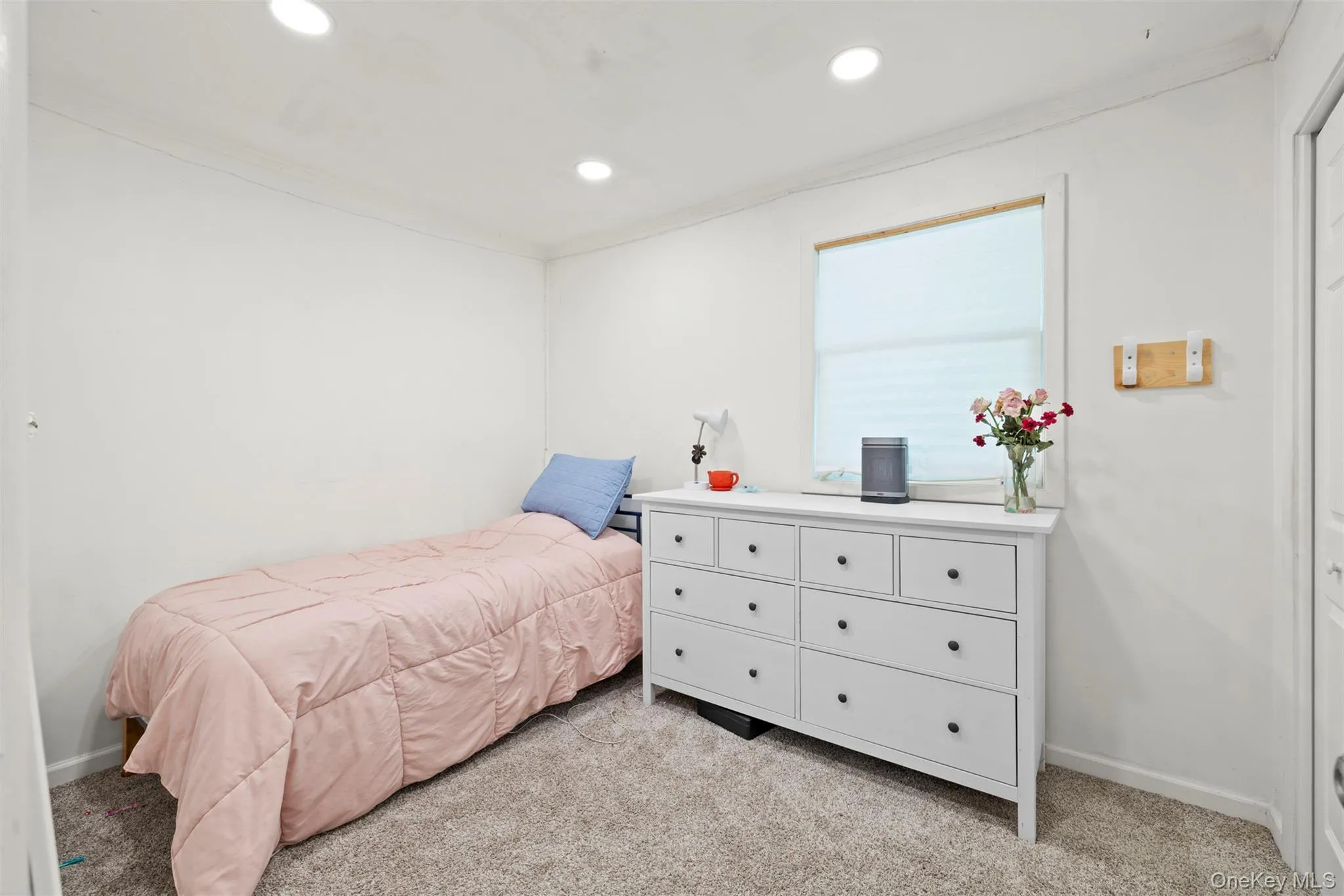 Bedroom with light carpet, ornamental molding, and recessed lighting Bedroom with light carpet, ornamental molding, and recessed lighting