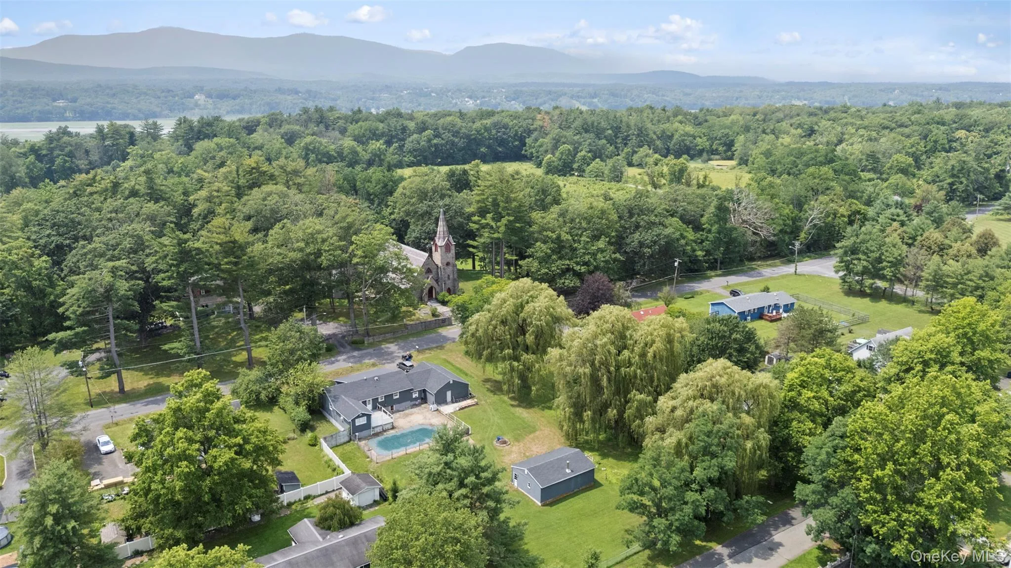 Aerial view of property's location with a mountain backdrop Aerial view of property's location with a mountain backdrop