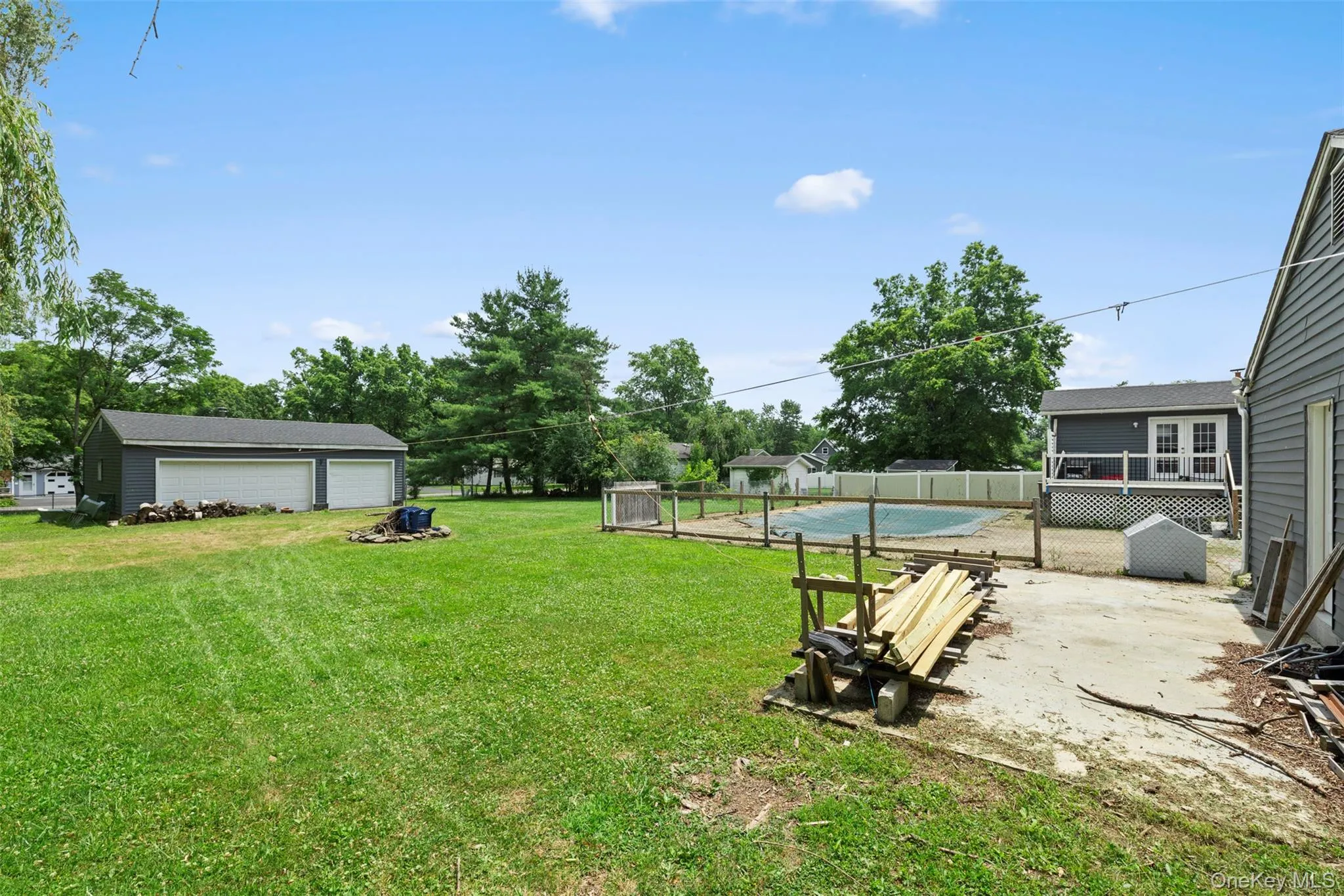 View of yard with a garage View of yard with a garage