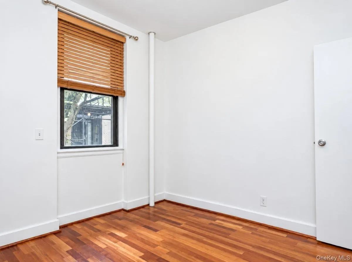 Rich wood-finish flooring with crisp white walls Rich wood-finish flooring with crisp white walls