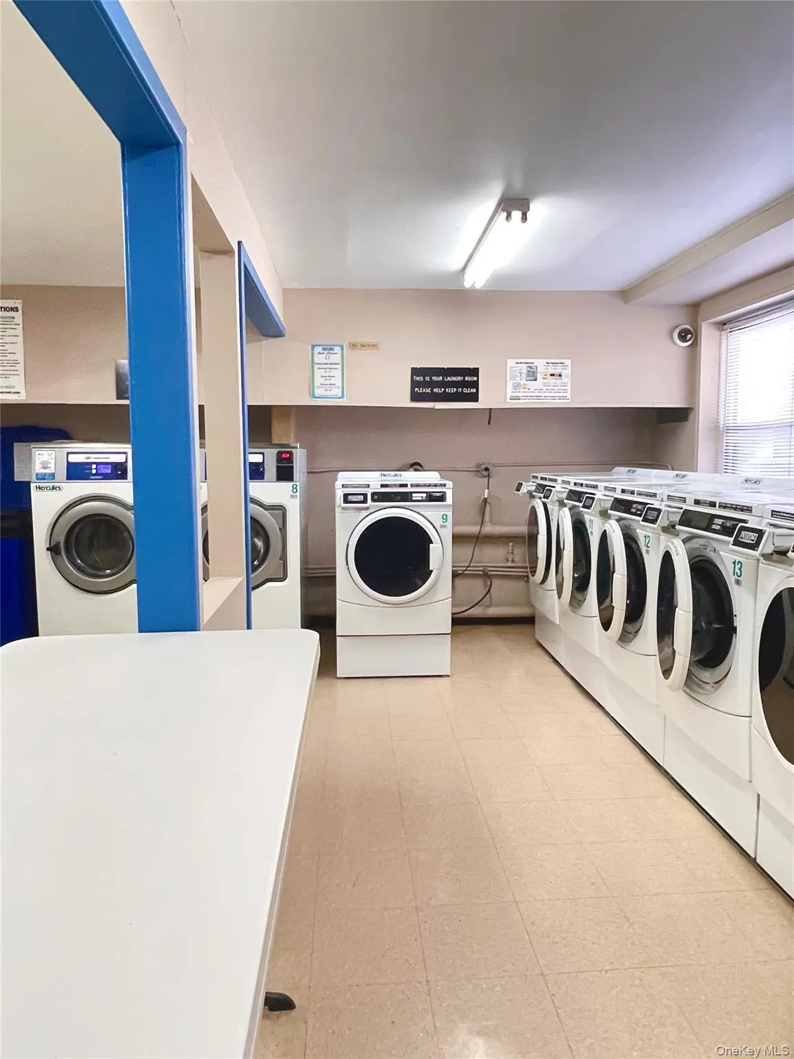 Community laundry with washer and dryer and light flooring Community laundry with washer and dryer and light flooring