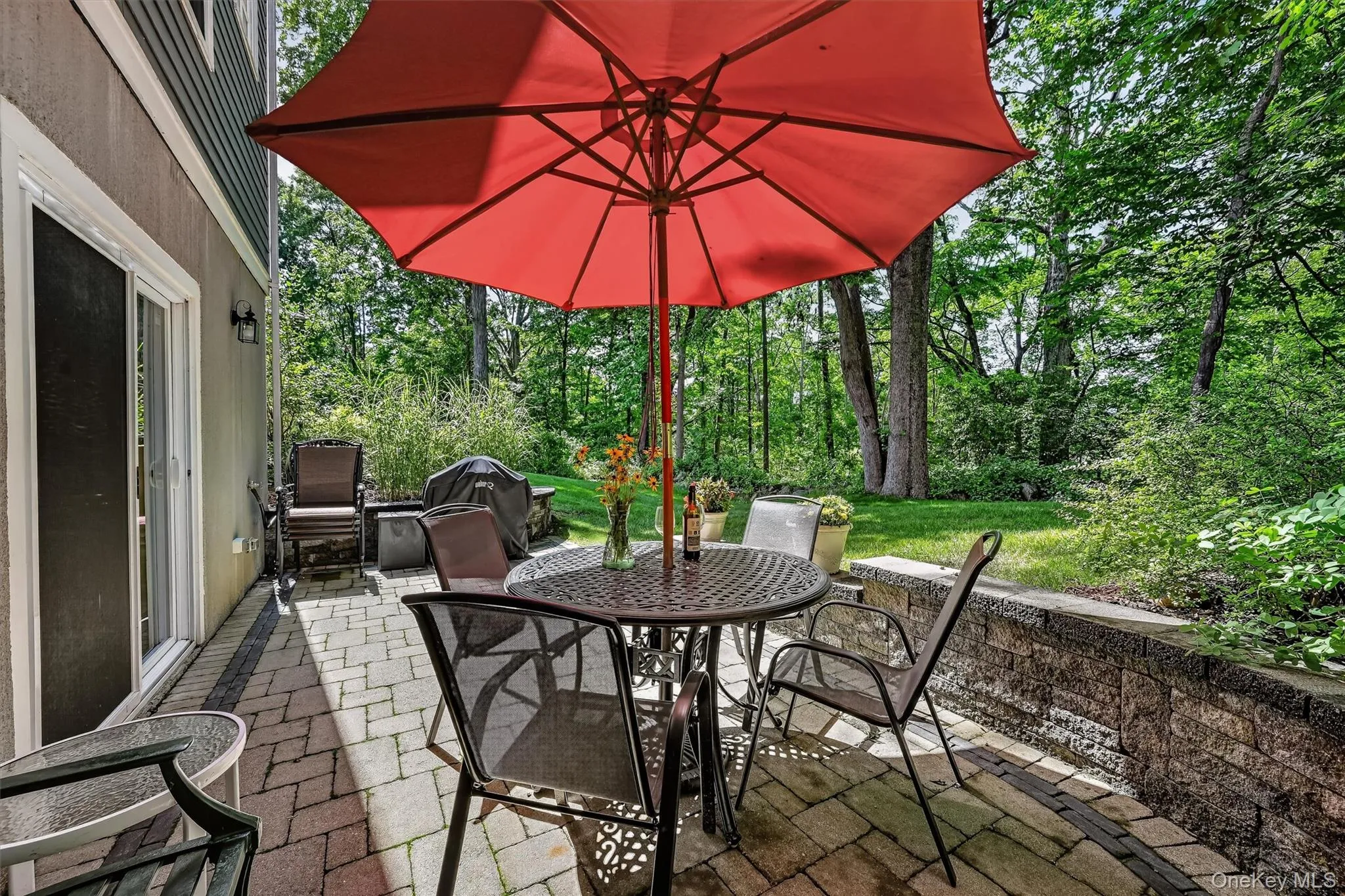 The patio is defined by the stunning sitting stone wall. The patio is defined by the stunning sitting stone wall.