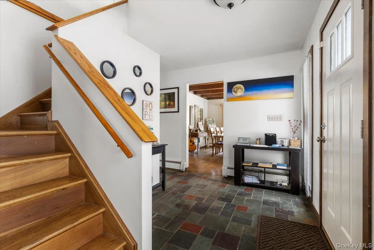 Entry & Staircase – Welcoming foyer with wood staircase and natural light. Entry & Staircase – Welcoming foyer with wood staircase and natural light.