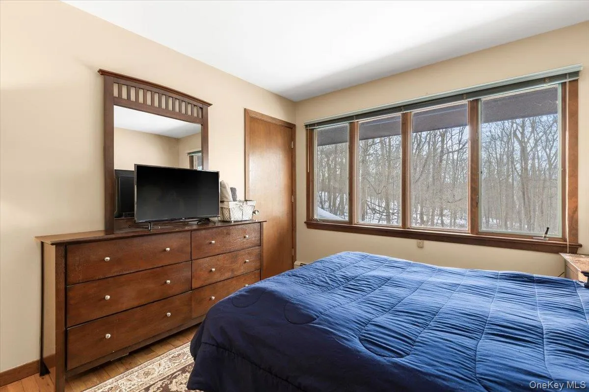 Bedroom – with large windows overlooking wooded grounds. Bedroom – with large windows overlooking wooded grounds.