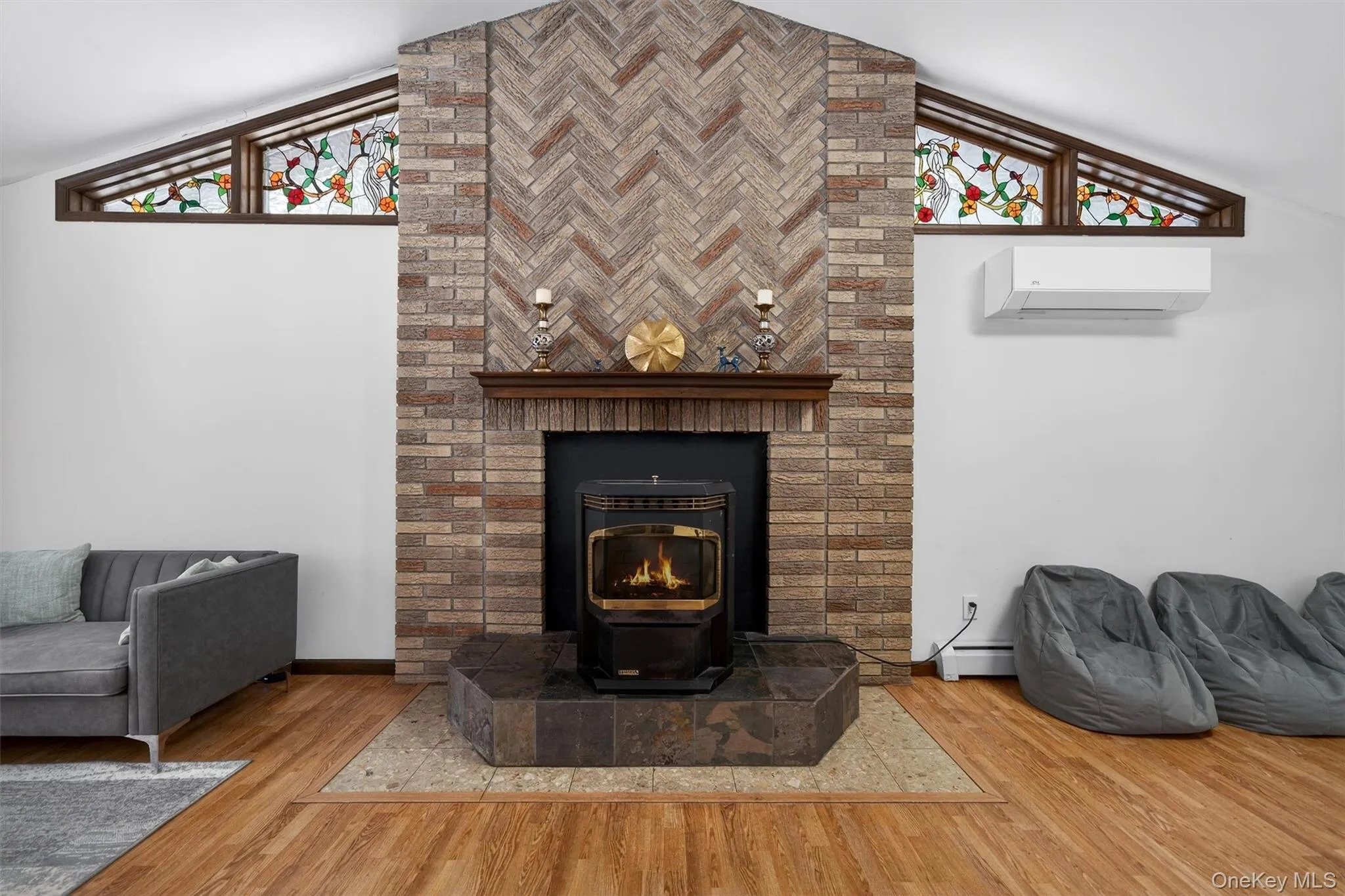 Detailed view of wood finished floors, a mini split for heating / cooling, and a baseboard radiator Detailed view of wood finished floors, a mini split for heating / cooling, and a baseboard radiator