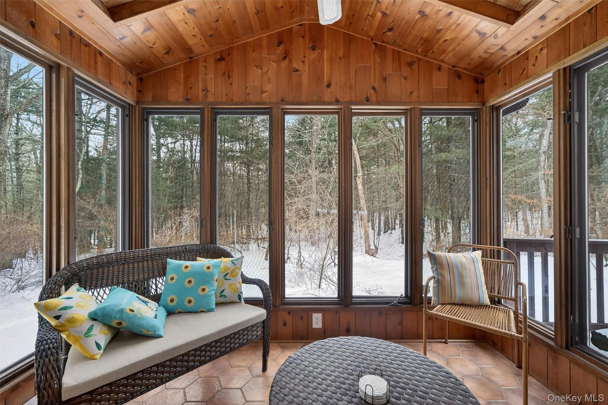 Sunroom with view of wooded area Sunroom with view of wooded area