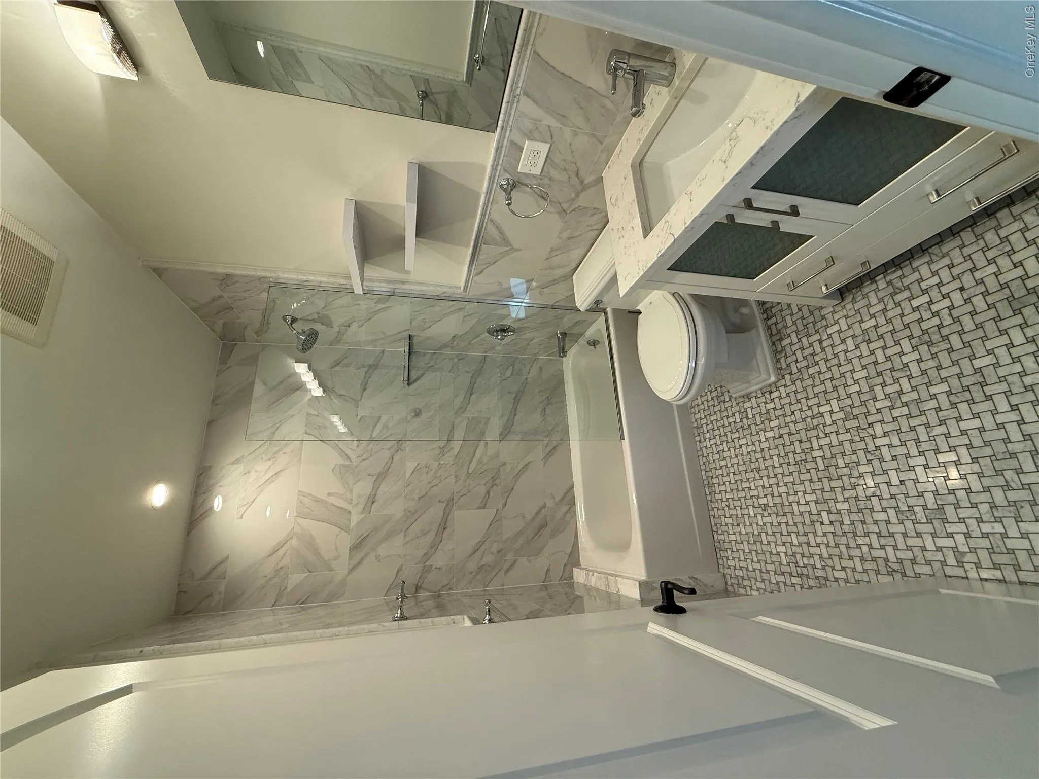 Bathroom featuring washtub / shower combination, vanity, and tile walls Bathroom featuring washtub / shower combination, vanity, and tile walls