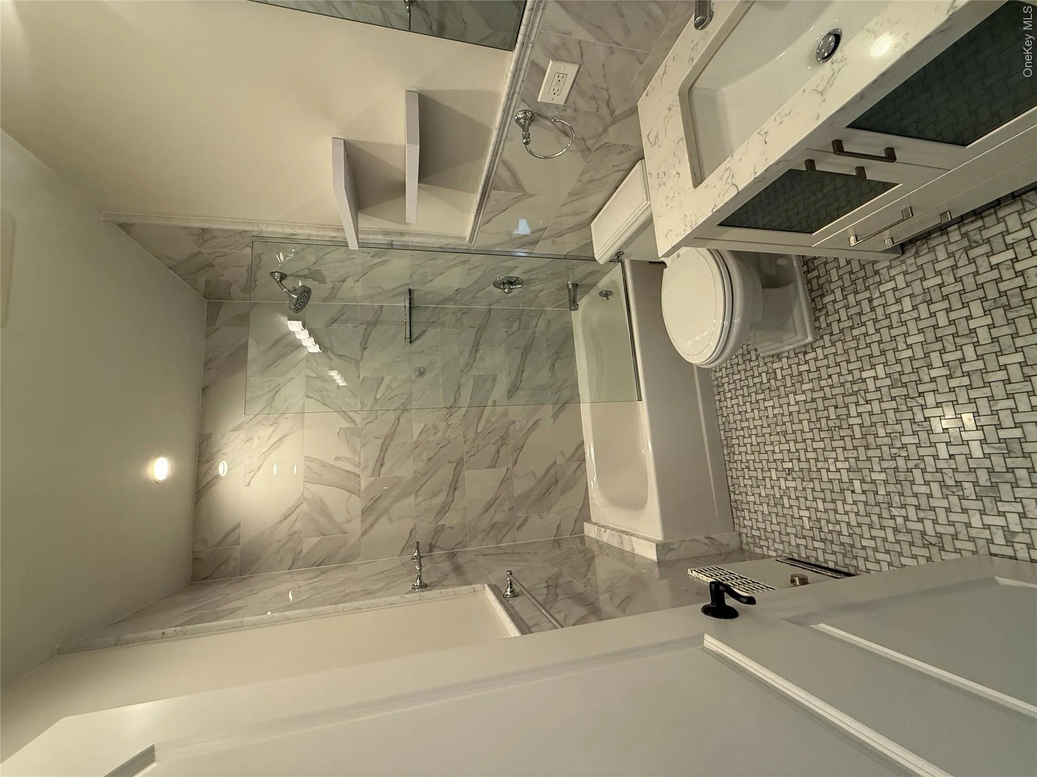 Full bath featuring shower / washtub combination, vanity, and tile walls Full bath featuring shower / washtub combination, vanity, and tile walls