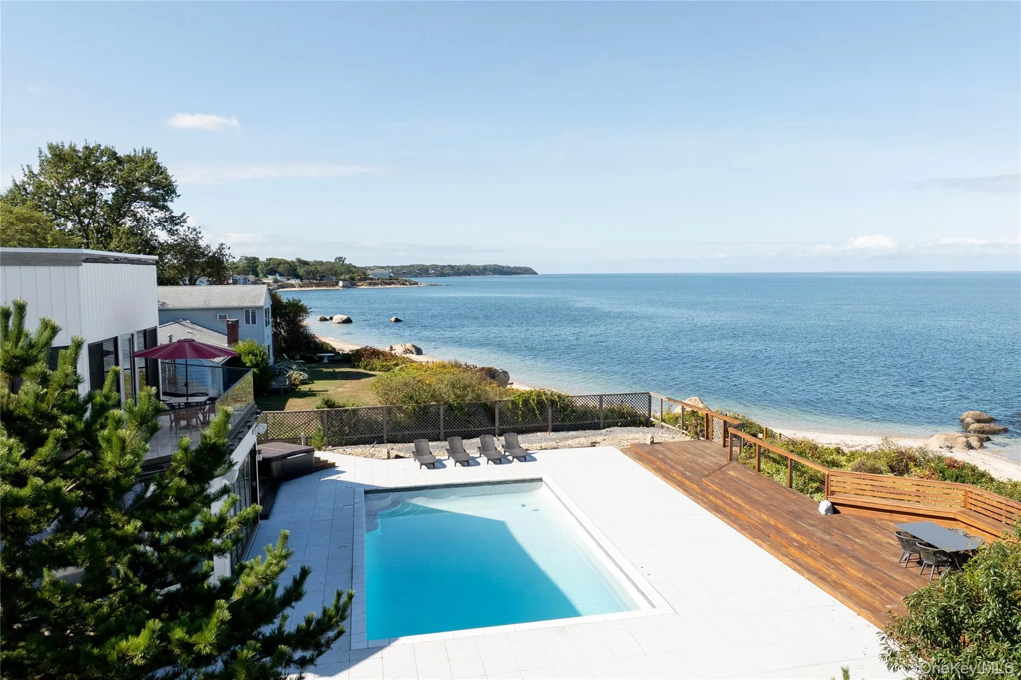 View of pool featuring fence, a fenced in pool, a patio, and a deck with water view View of pool featuring fence, a fenced in pool, a patio, and a deck with water view