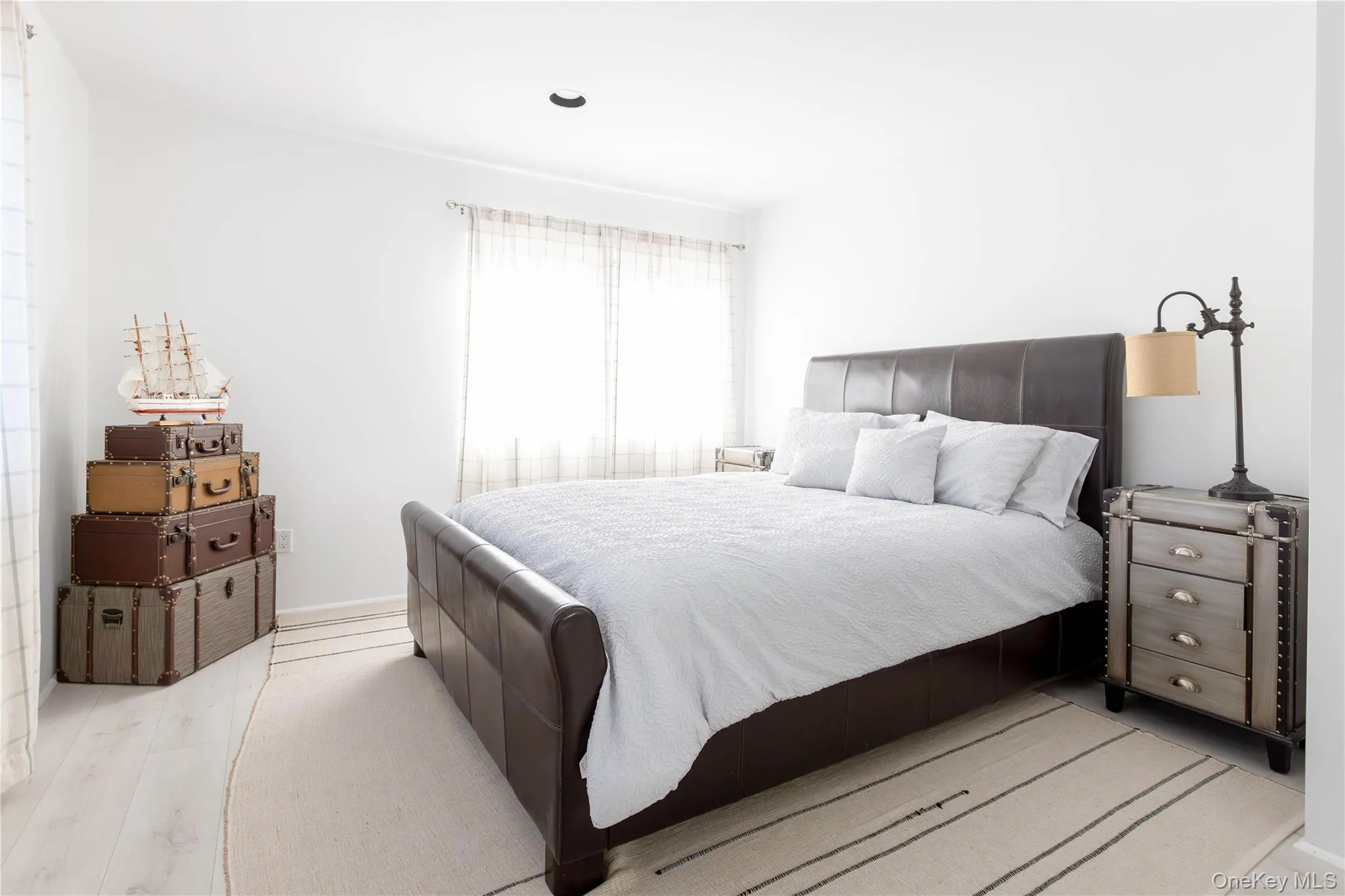 Bedroom with light wood-style flooring Bedroom with light wood-style flooring