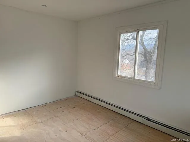 Spare room featuring a baseboard heating unit Spare room featuring a baseboard heating unit