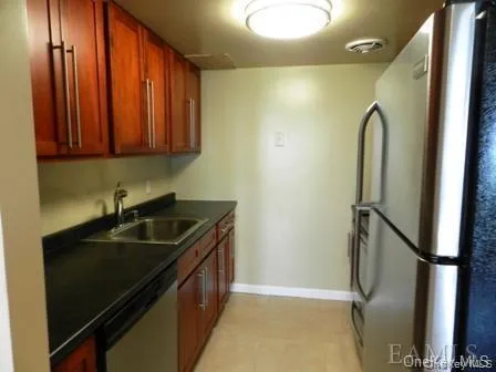 Kitchen featuring sink and appliances with stainless steel finishes Kitchen featuring sink and appliances with stainless steel finishes