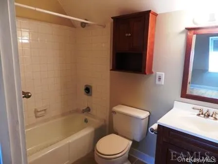 Full bathroom with tiled shower / bath, vanity, and toilet Full bathroom with tiled shower / bath, vanity, and toilet