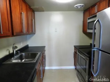 Kitchen featuring appliances with stainless steel finishes and sink Kitchen featuring appliances with stainless steel finishes and sink