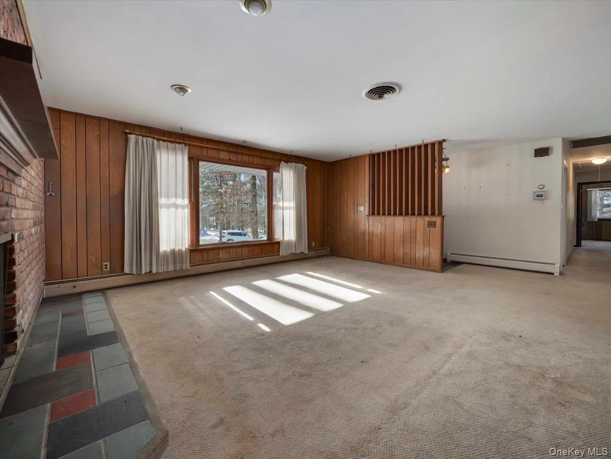 Large open Living room with picture window and brick fireplace Large open Living room with picture window and brick fireplace