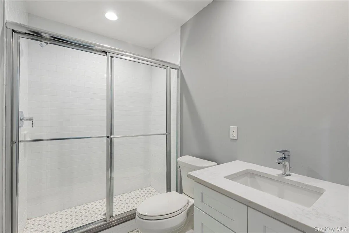 Bathroom – Modern full bath with glass-enclosed shower and updated vanity. Bathroom – Modern full bath with glass-enclosed shower and updated vanity.