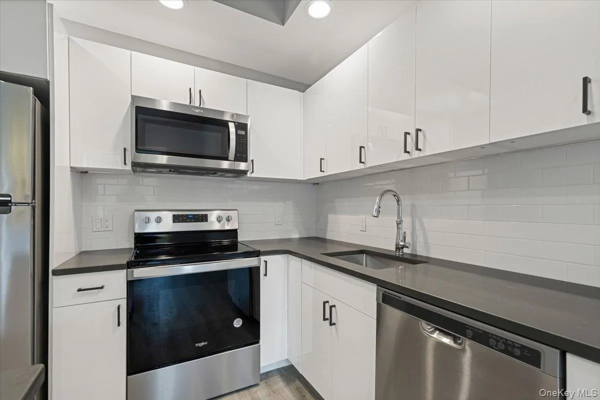 Kitchen – Appliance Detail – Energy Star stainless steel appliances, sleek cabinetry, and contemporary backsplash. Kitchen – Appliance Detail – Energy Star stainless steel appliances, sleek cabinetry, and contemporary backsplash.