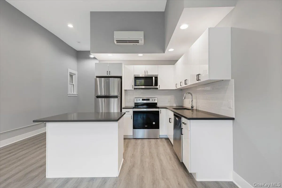 Kitchen – Island View – Open-concept kitchen featuring quartz countertops, stainless steel appliances, and center island with seating. Kitchen – Island View – Open-concept kitchen featuring quartz countertops, stainless steel appliances, and center island with seating.