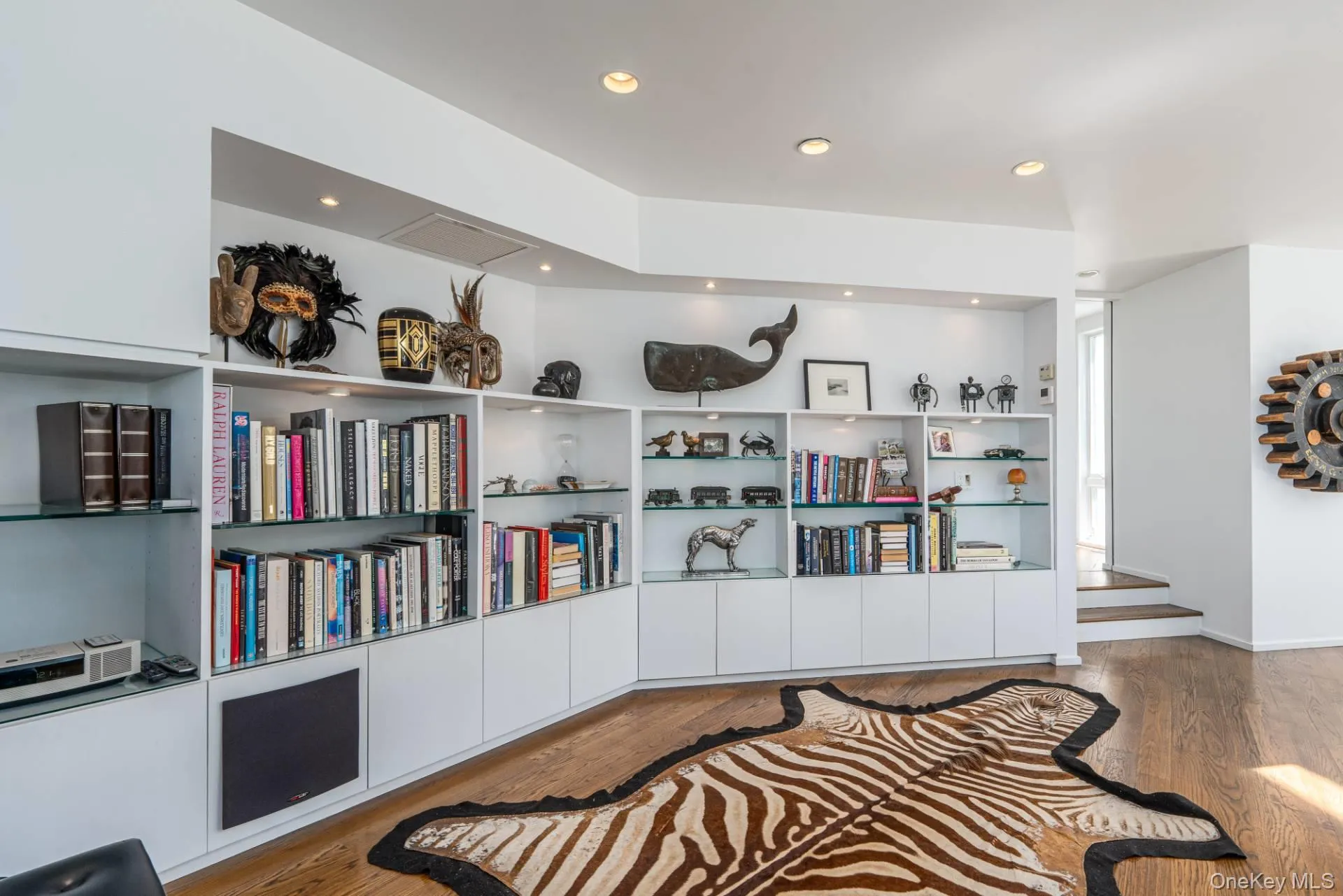 Living room upper level with custom bookcases, Sonos sound system Living room upper level with custom bookcases, Sonos sound system
