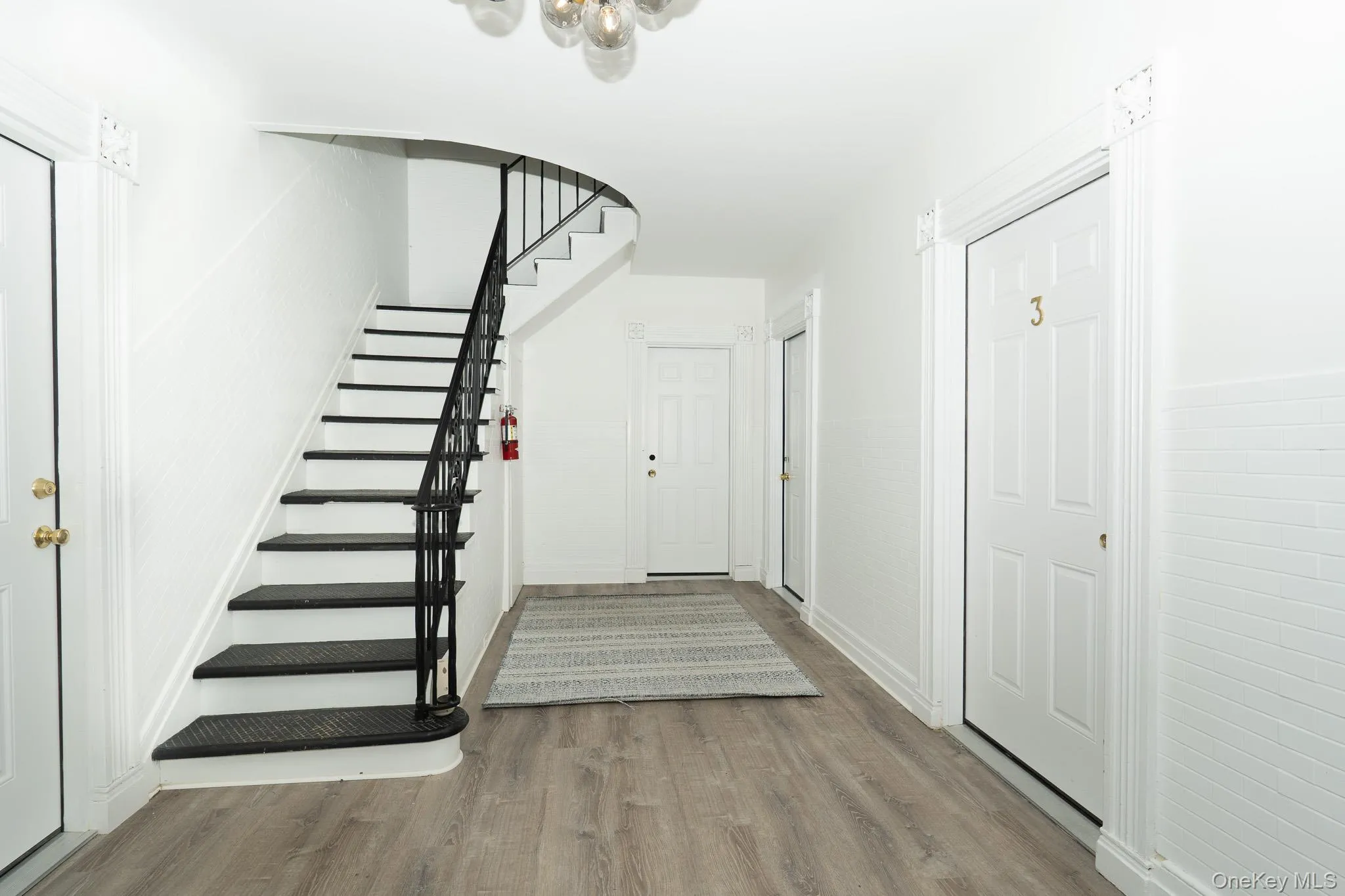 Entryway with stairs and wood finished floors Entryway with stairs and wood finished floors
