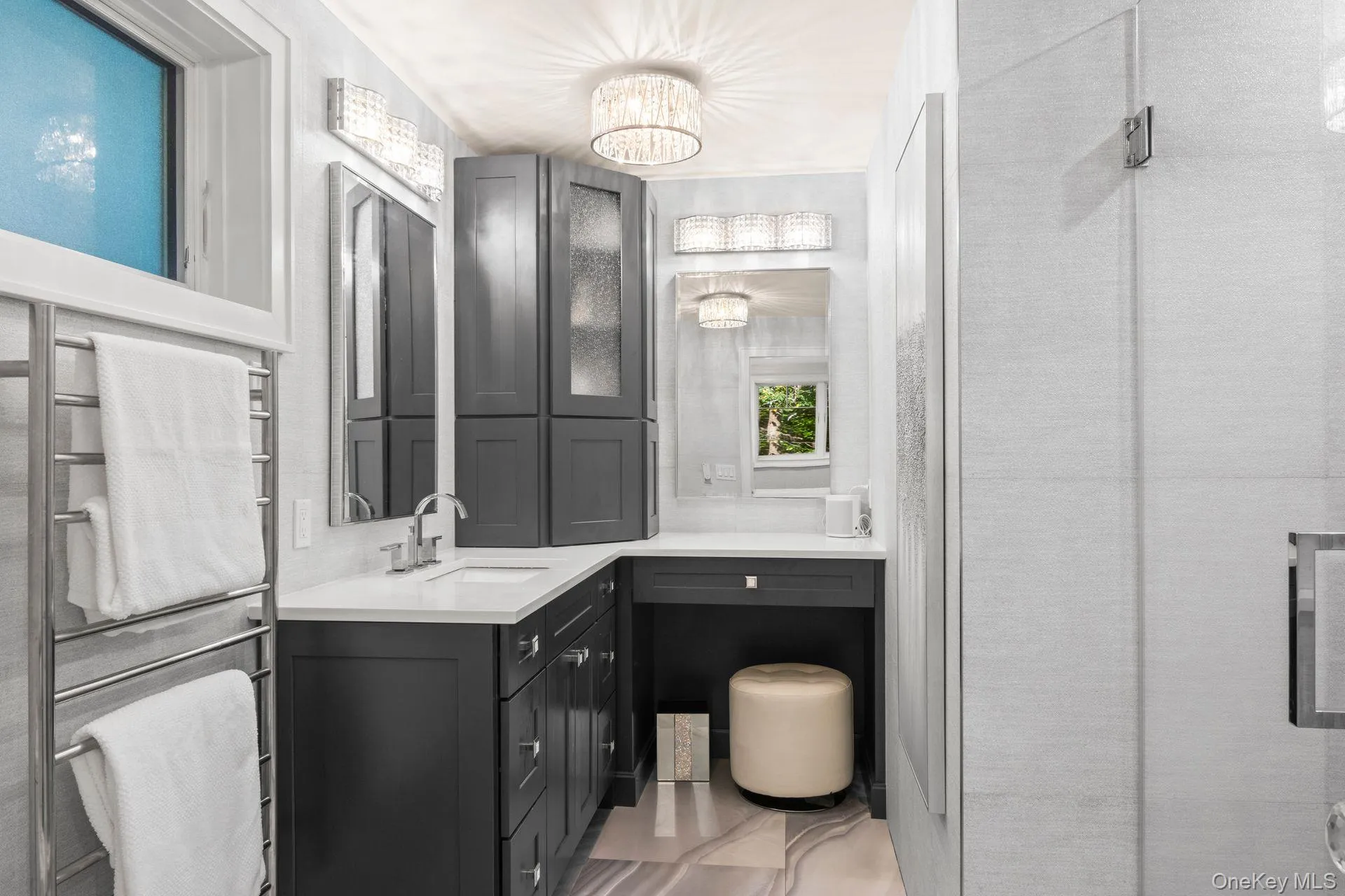 Primary bathroom features a vanity, sink and walk-in shower Primary bathroom features a vanity, sink and walk-in shower