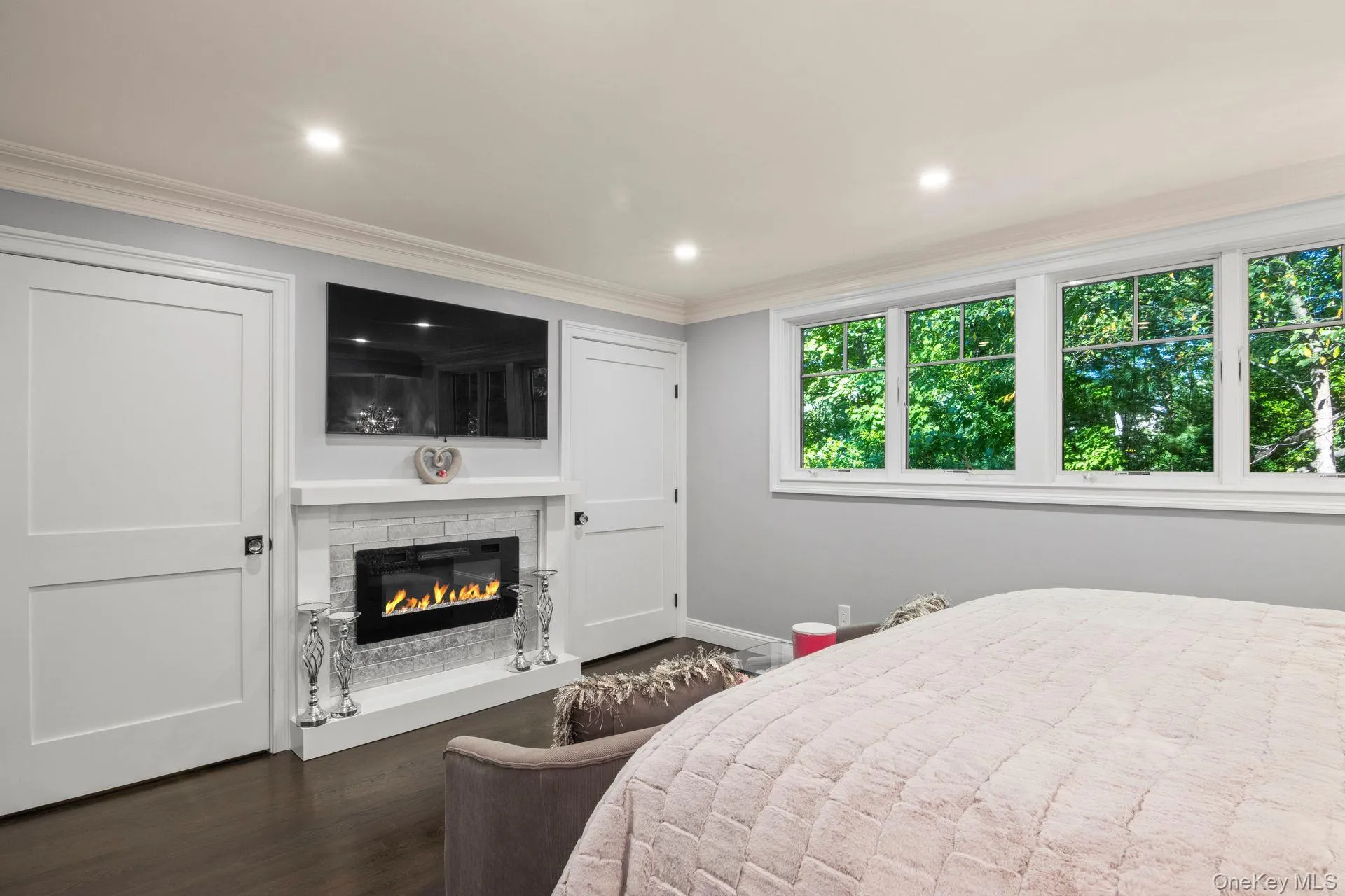 Primary Bedroom Suite features a fireplace and two closets. Primary Bedroom Suite features a fireplace and two closets.