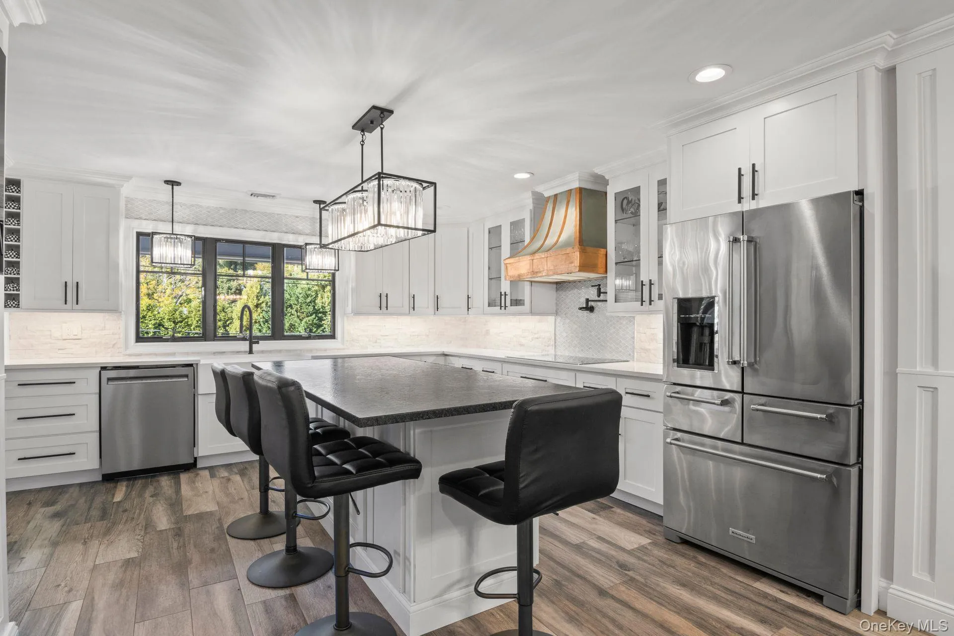 Kitchen with stainless steel appliances, granite counters, white cabinets, and recessed lighting Kitchen with stainless steel appliances, granite counters, white cabinets, and recessed lighting