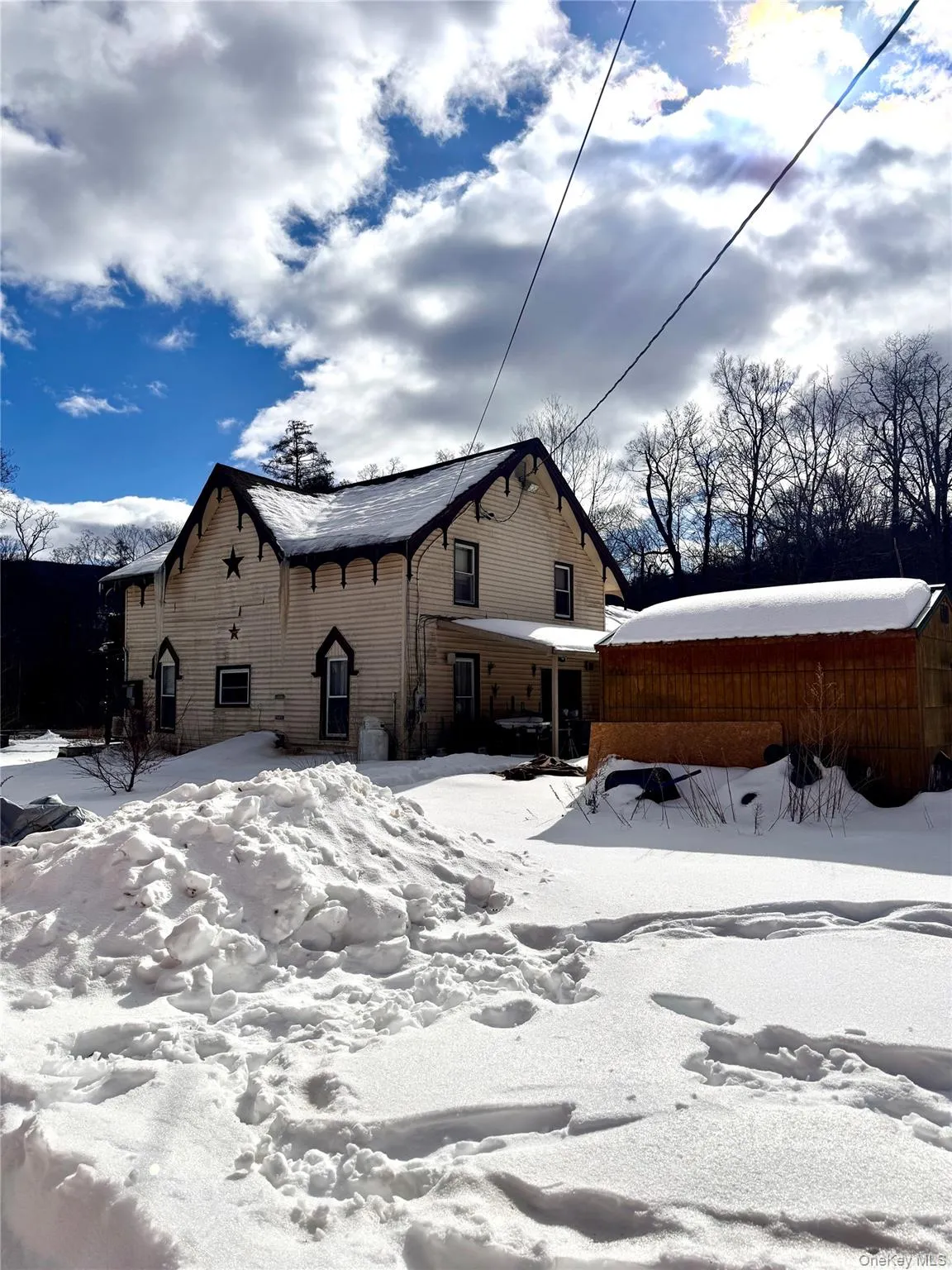 A view looking towards the back of the property showing the covered back patio and large shed. A view looking towards the back of the property showing the covered back patio and large shed.