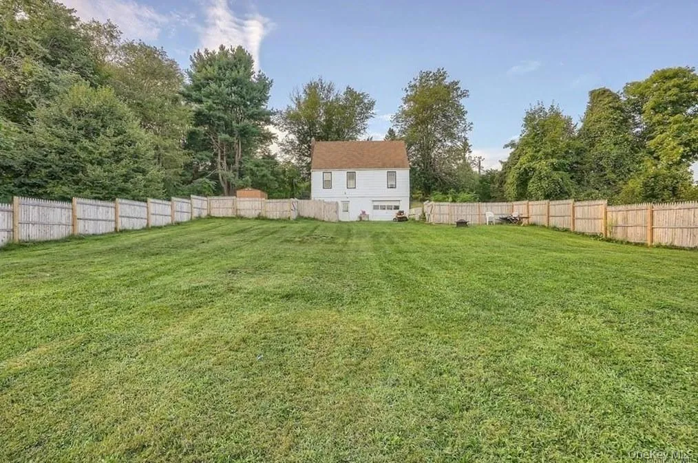 Fenced backyard featuring view of wooded area Fenced backyard featuring view of wooded area