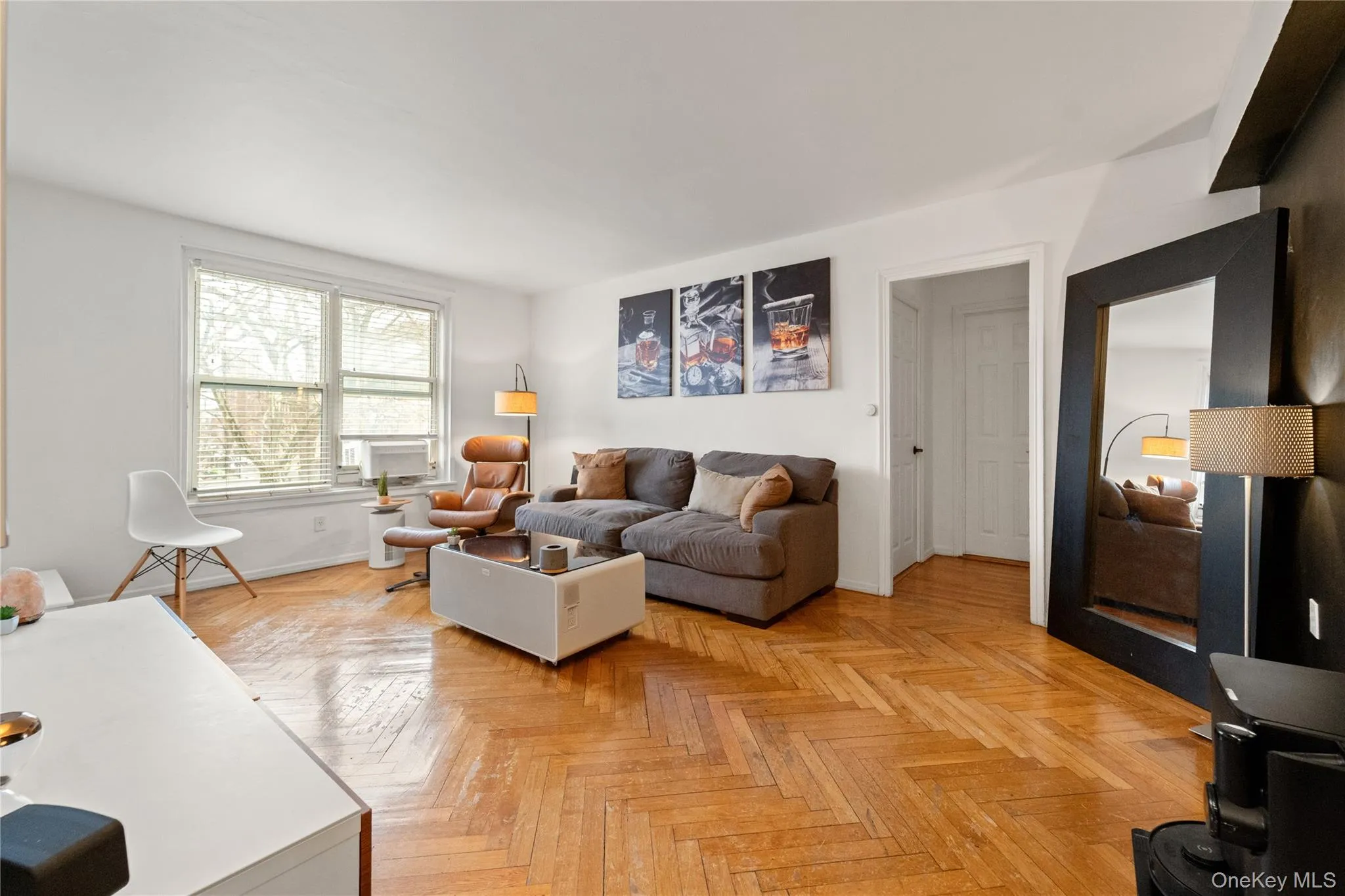 Living area featuring parquet floors and baseboards Living area featuring parquet floors and baseboards