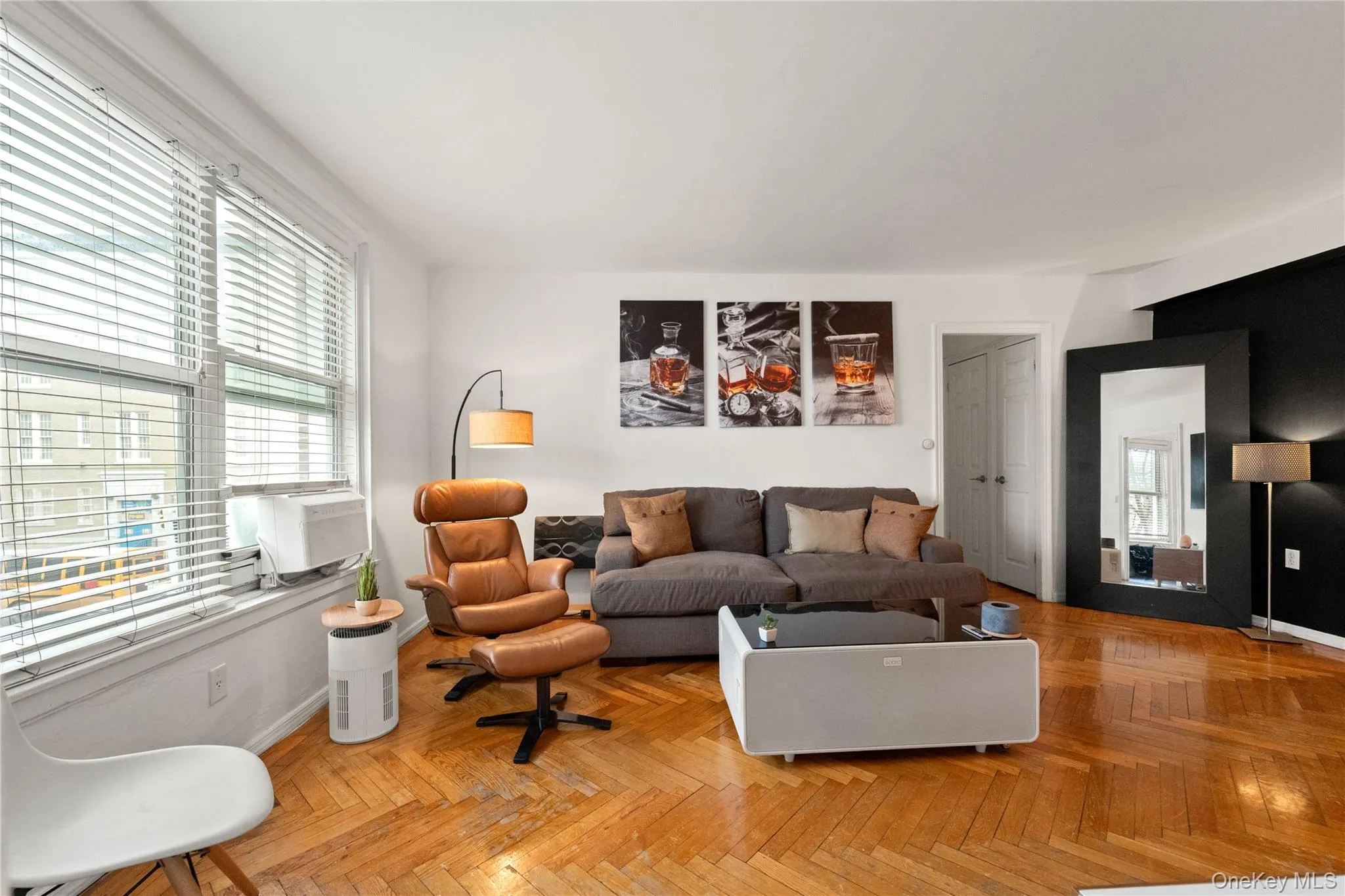 Living area featuring parquet floors and cooling unit Living area featuring parquet floors and cooling unit