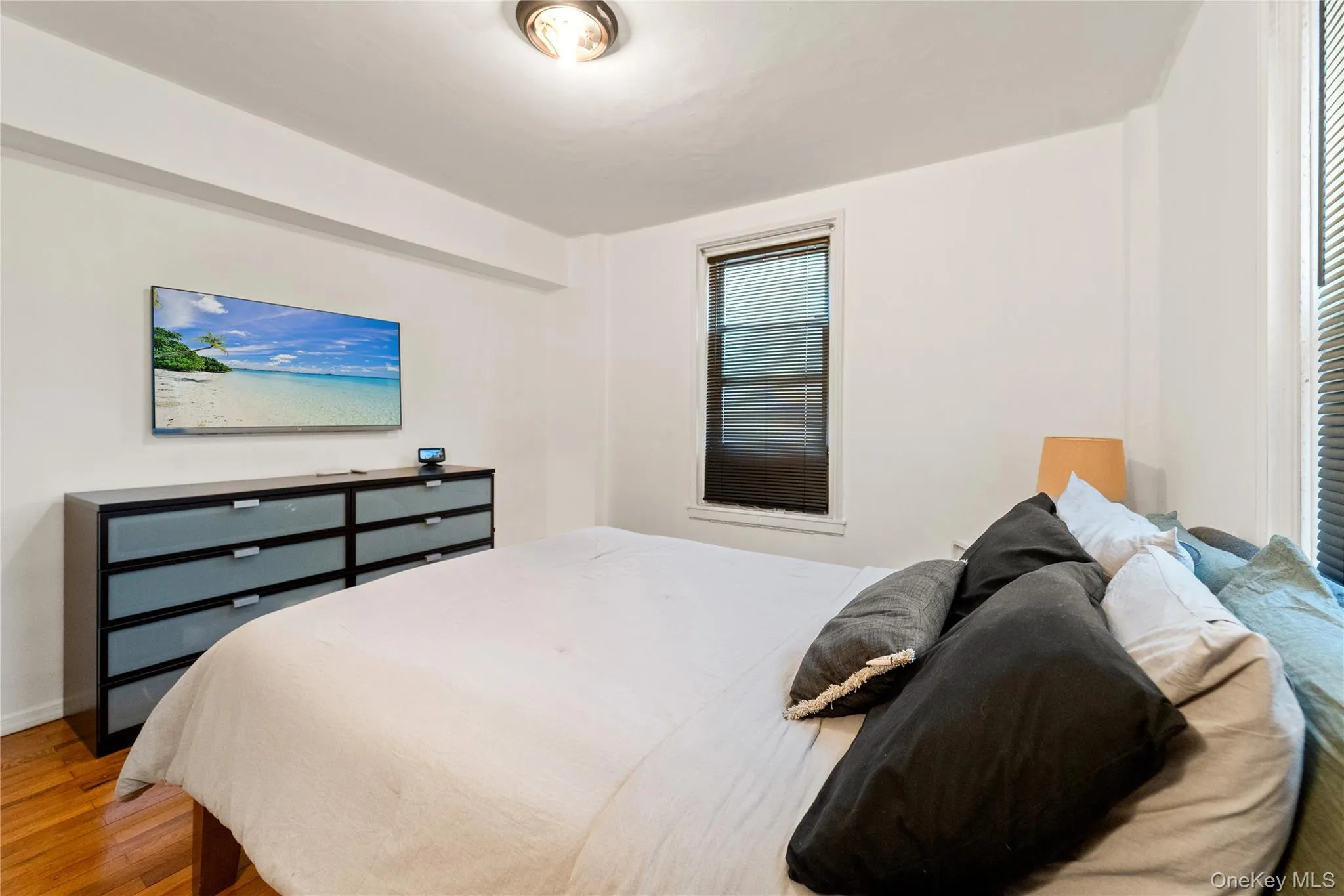 Bedroom featuring light wood-type flooring and baseboards Bedroom featuring light wood-type flooring and baseboards