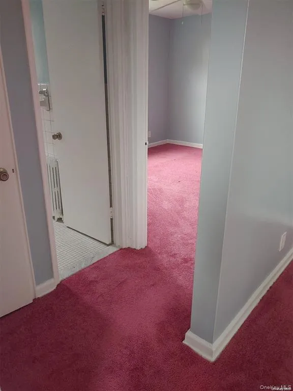 Corridor featuring carpet and radiator Corridor featuring carpet and radiator