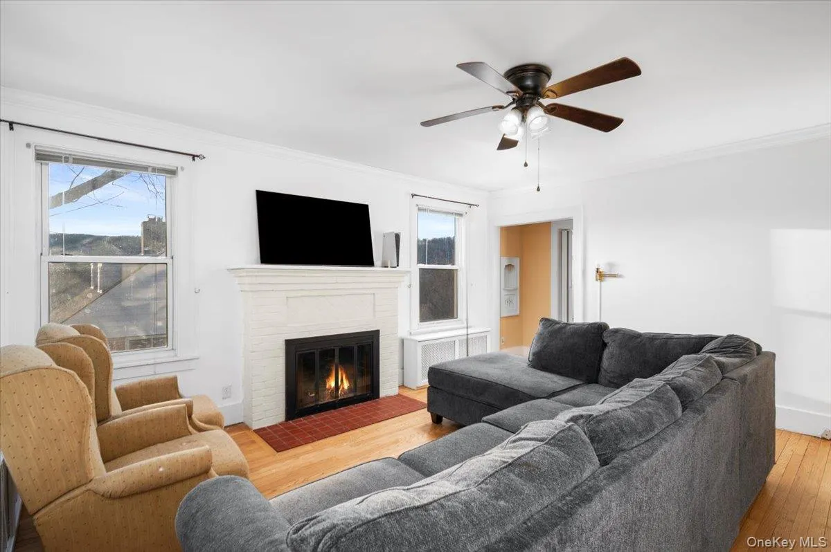 Living Room area with light wood finished floors, a fireplace ( not functioning ) Living Room area with light wood finished floors, a fireplace ( not functioning )