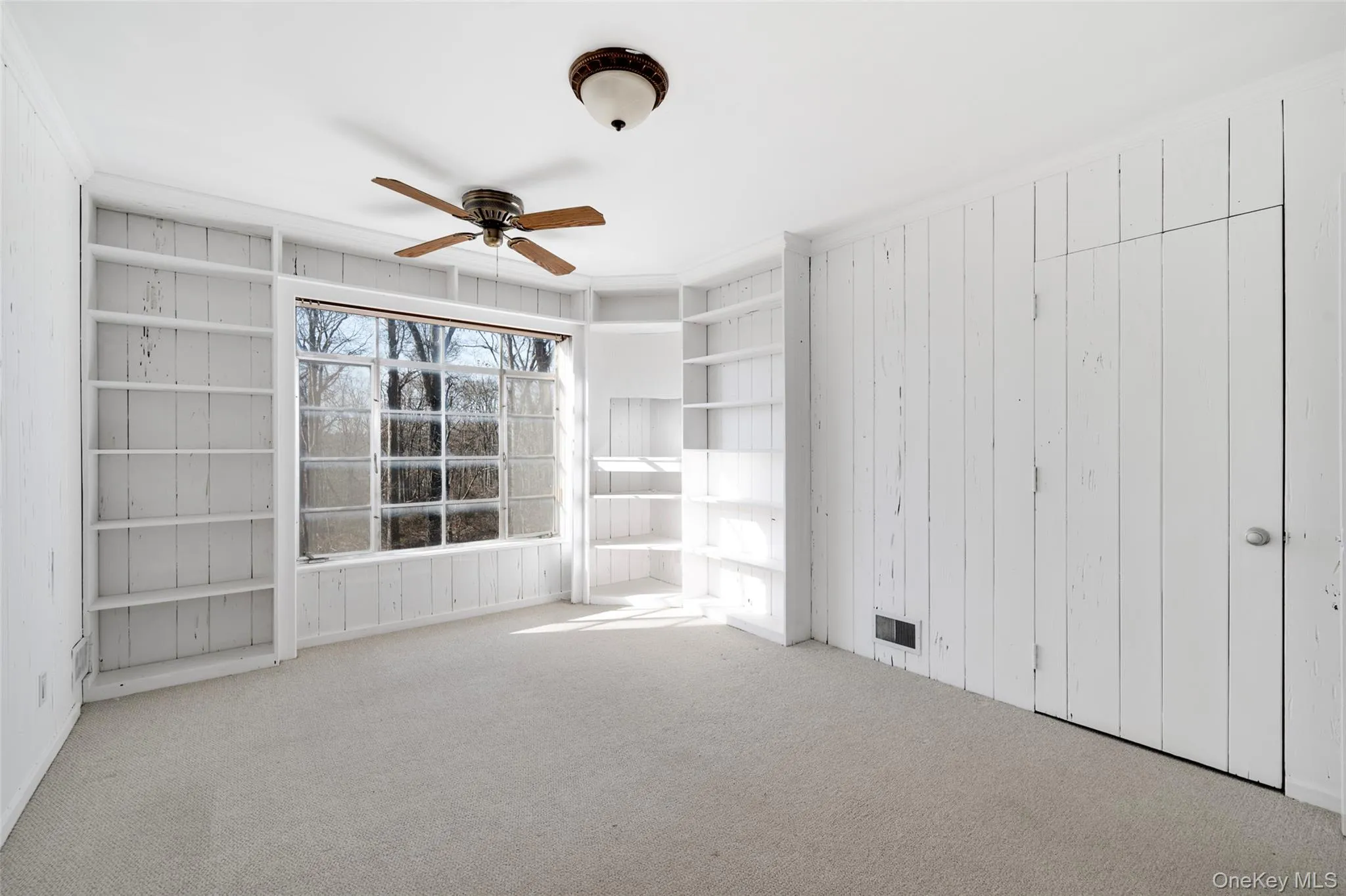 Unfurnished room with light carpet, crown molding, and ceiling fan Unfurnished room with light carpet, crown molding, and ceiling fan