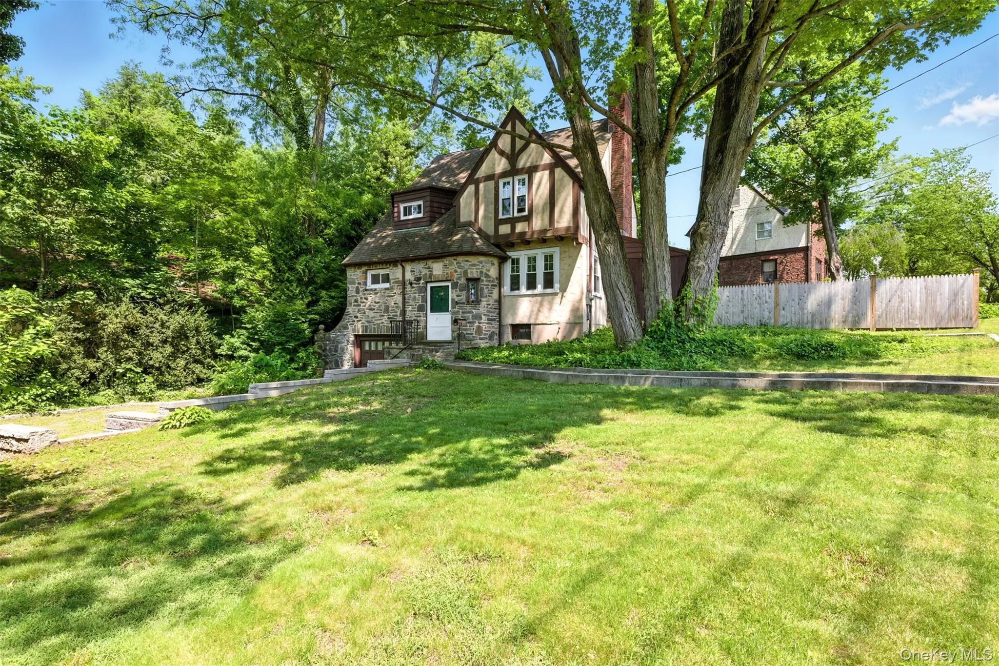 Tudor home with stone siding Tudor home with stone siding