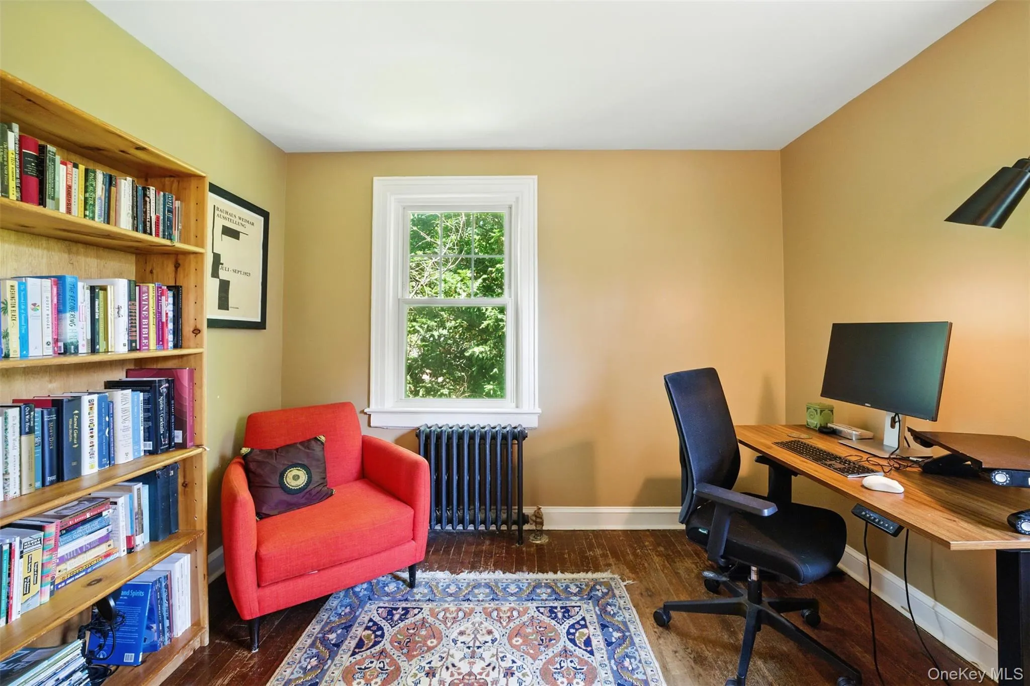 Alternate view of 3rd bedroom being used as Office space featuring radiator and wood finished floors Alternate view of 3rd bedroom being used as Office space featuring radiator and wood finished floors