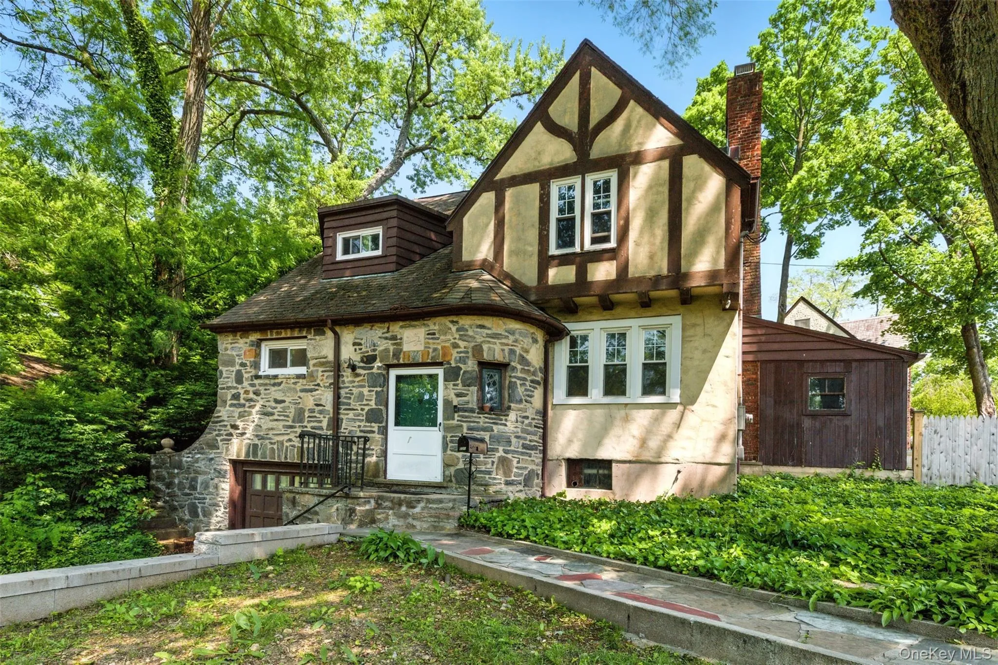 Alternate right side view of home with a chimney and stone siding Alternate right side view of home with a chimney and stone siding