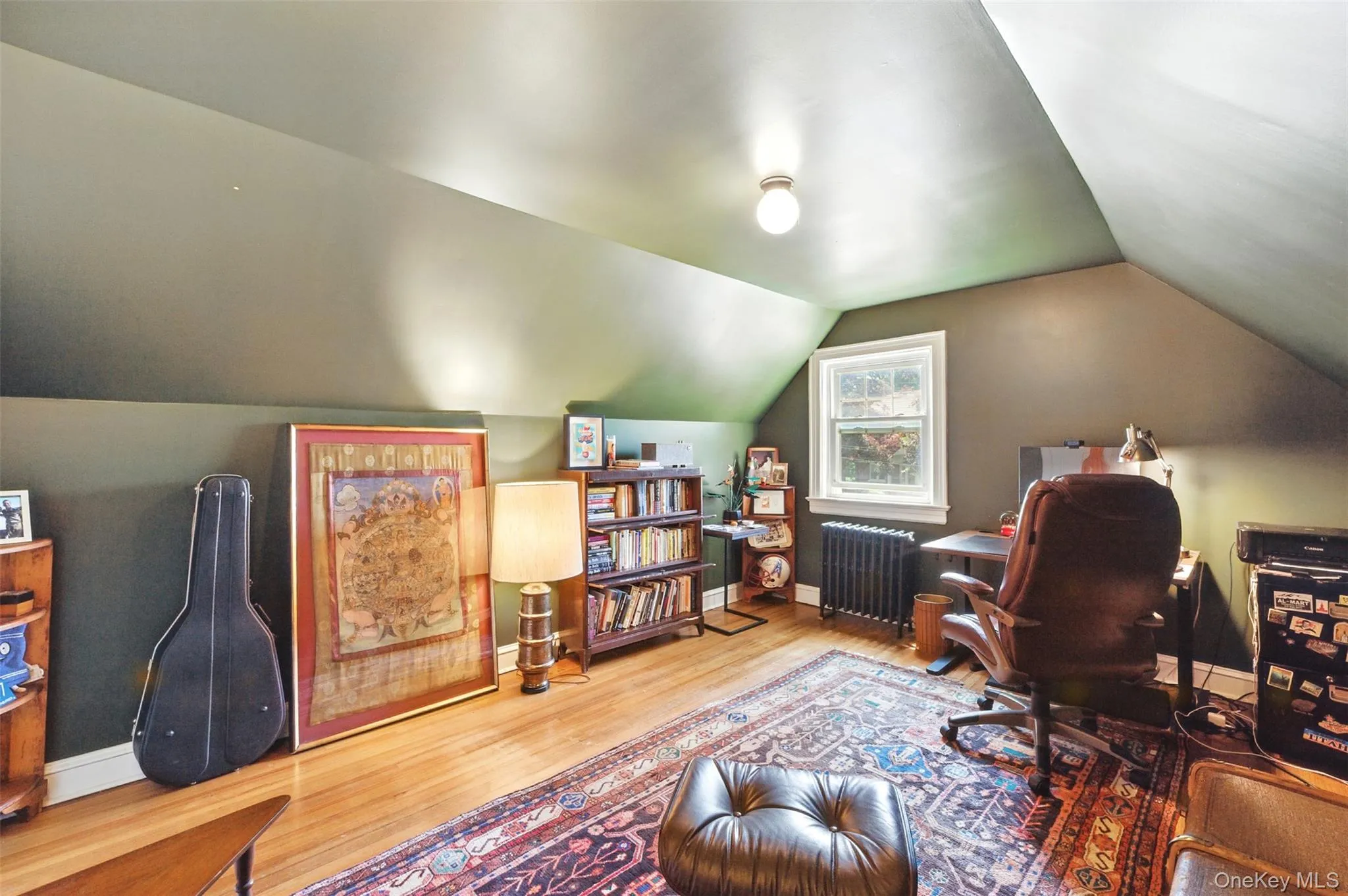 4th Bedroom being used as Office area with radiator, wood finished floors, and vaulted ceiling 4th Bedroom being used as Office area with radiator, wood finished floors, and vaulted ceiling