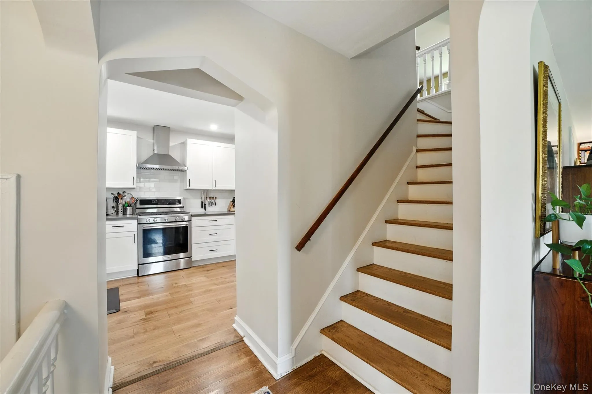 Stairway featuring wood finished floors and recessed lighting Stairway featuring wood finished floors and recessed lighting