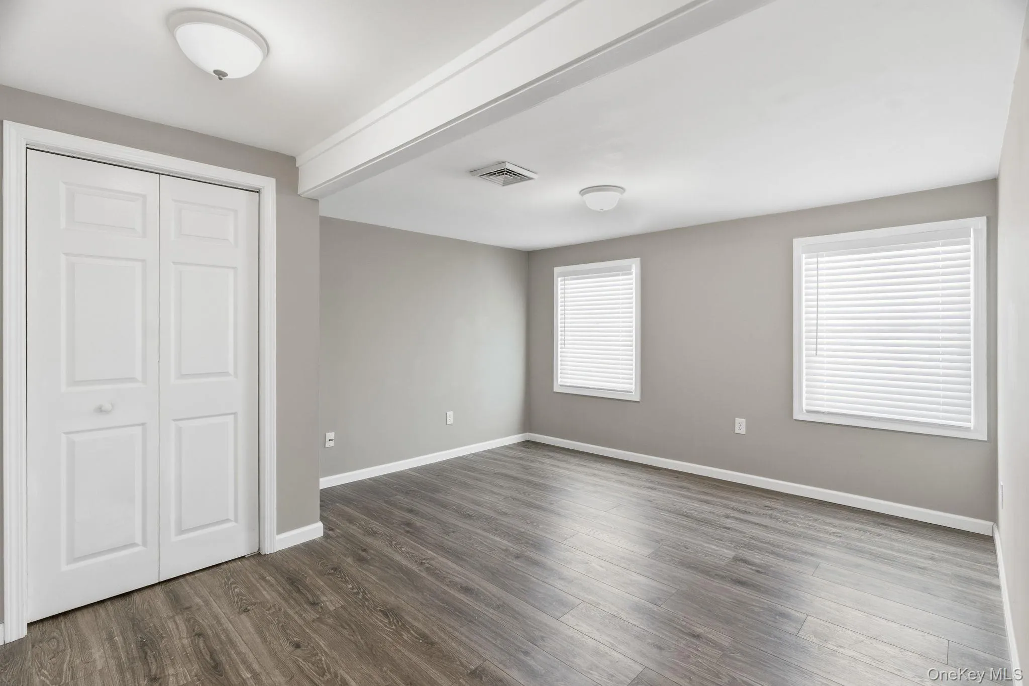 Spacious Primary Bedroom with ceiling beam Spacious Primary Bedroom with ceiling beam