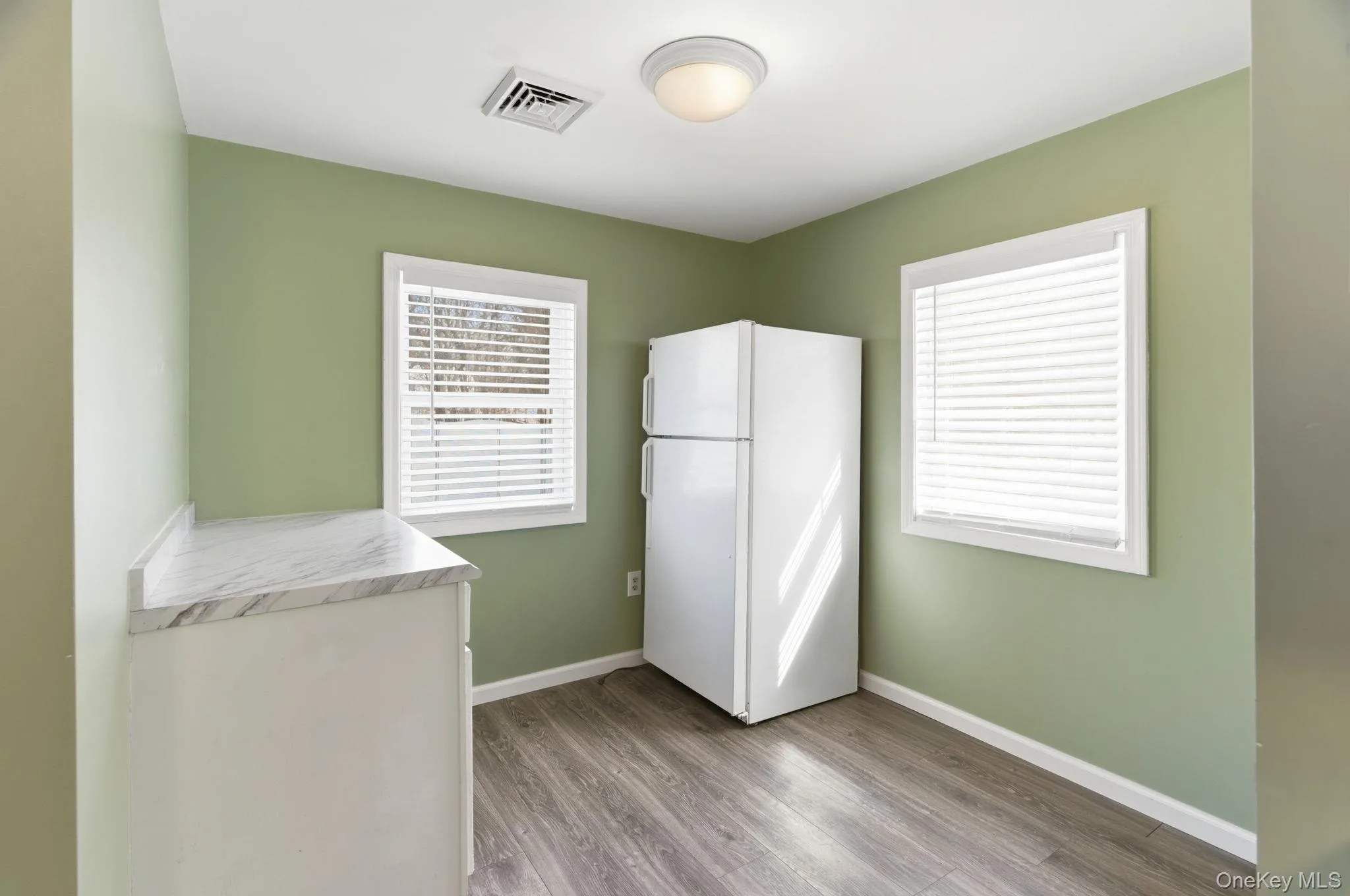 Eat in Kitchen area with refrigerator and cabinets Eat in Kitchen area with refrigerator and cabinets