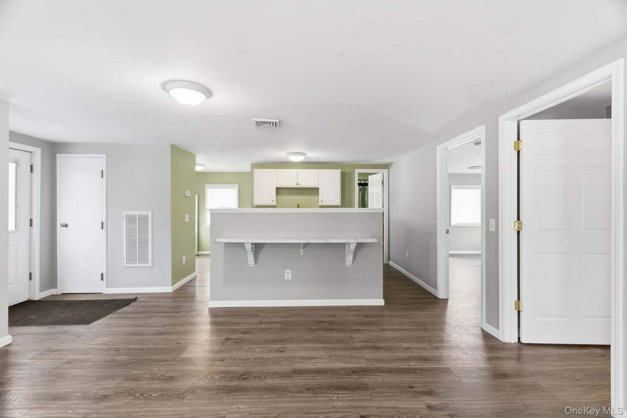 Open floor plan with living room, dining area and kitchen. Side entrance Open floor plan with living room, dining area and kitchen. Side entrance